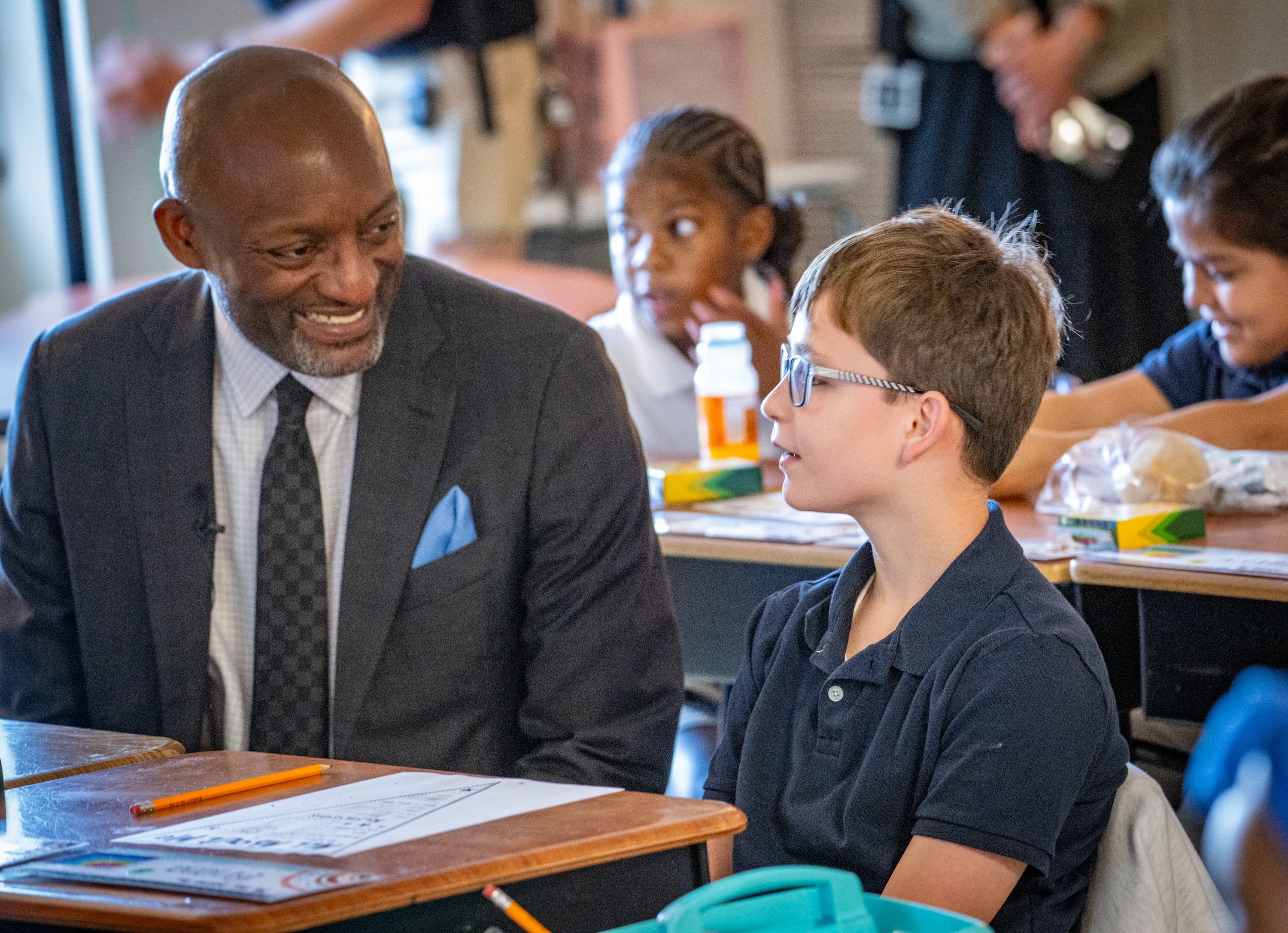 Anne Arundel County Public Schools Superintendent Mark Bedell talks with fourth grader Micah Chan in Rebekah Grossnickle’s class on the first day of school at Van Bokkelen Elementary.
