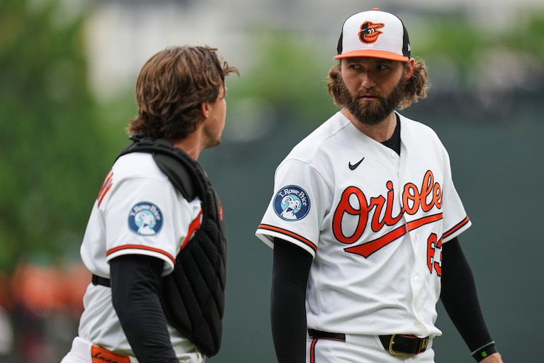 Baltimore Orioles starting pitcher Brandon Young, right, talks with catcher Adley Rutschman, left, while returning to the dugout after retiring the side during the second inning in the first baseball game of a doubleheader against the Detroit Tigers, Sunday, May 24, 2026, in Baltimore. (AP Photo/Stephanie Scarbrough)