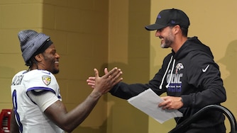 Baltimore Ravens head coach Jesse Minter shakes hands with Lamar Jackson after an NFL football game Sunday, Sept. 13, 2026, in Indianapolis.