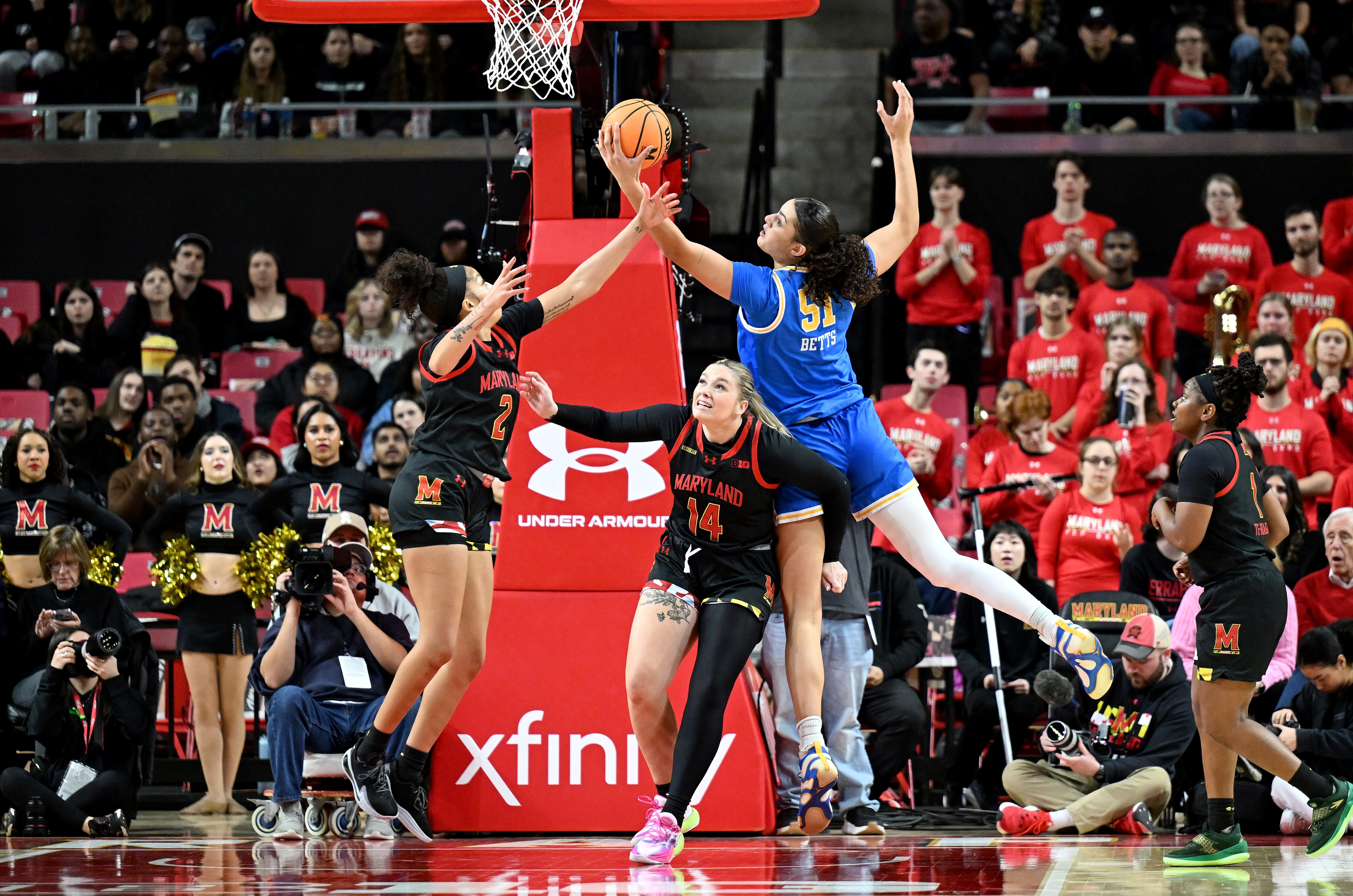 Lauren Betts of UCLA grabs a rebound against Kaylene Smikle, left, and Allie Kubek of Maryland during the third quarter Sunday.
