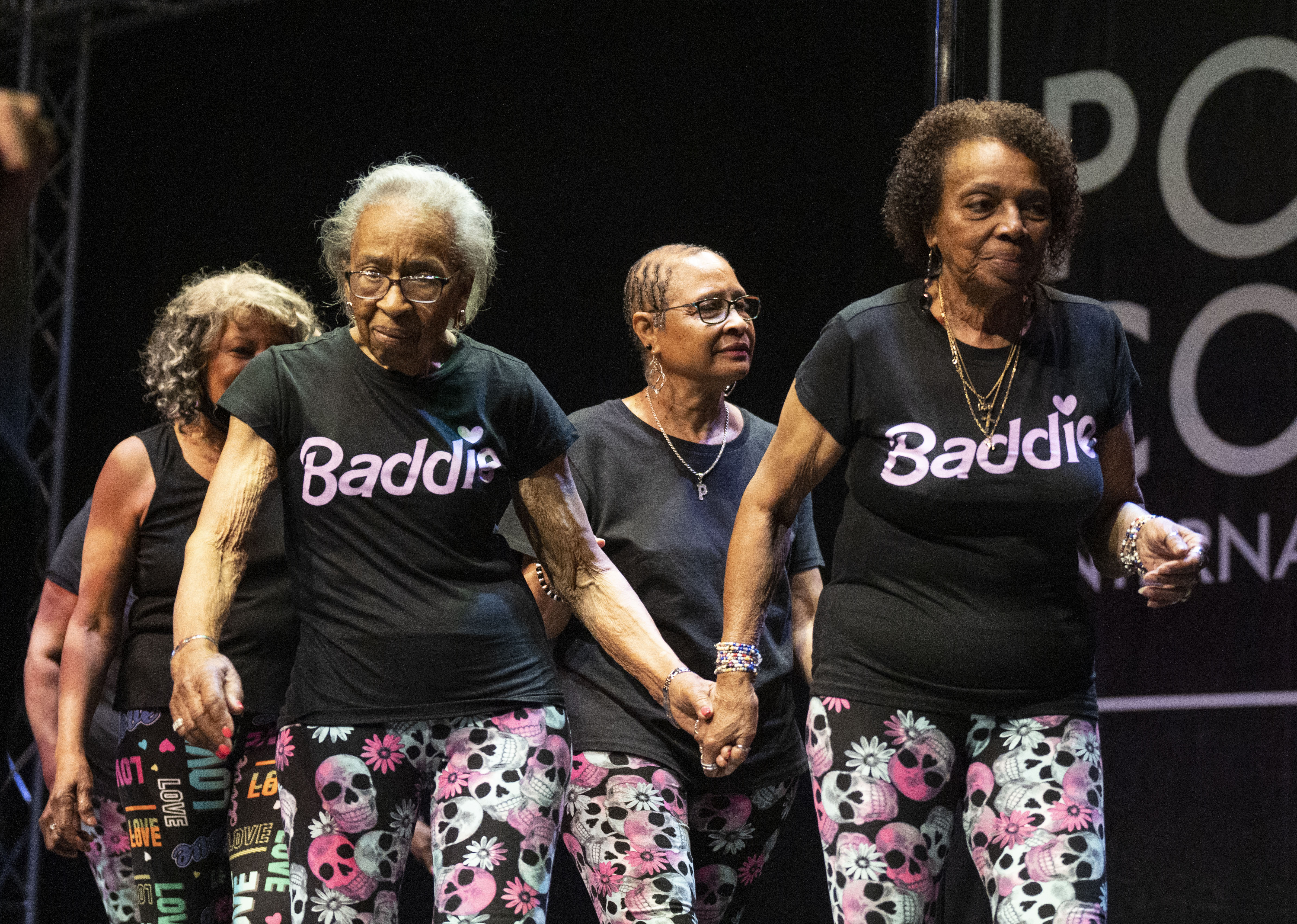 Idelia Brooks and Lois Cannon hold hands while walking off stage after performing at PoleCon International, at Live! Casino & Hotel Maryland, Saturday, June 17, 2023.