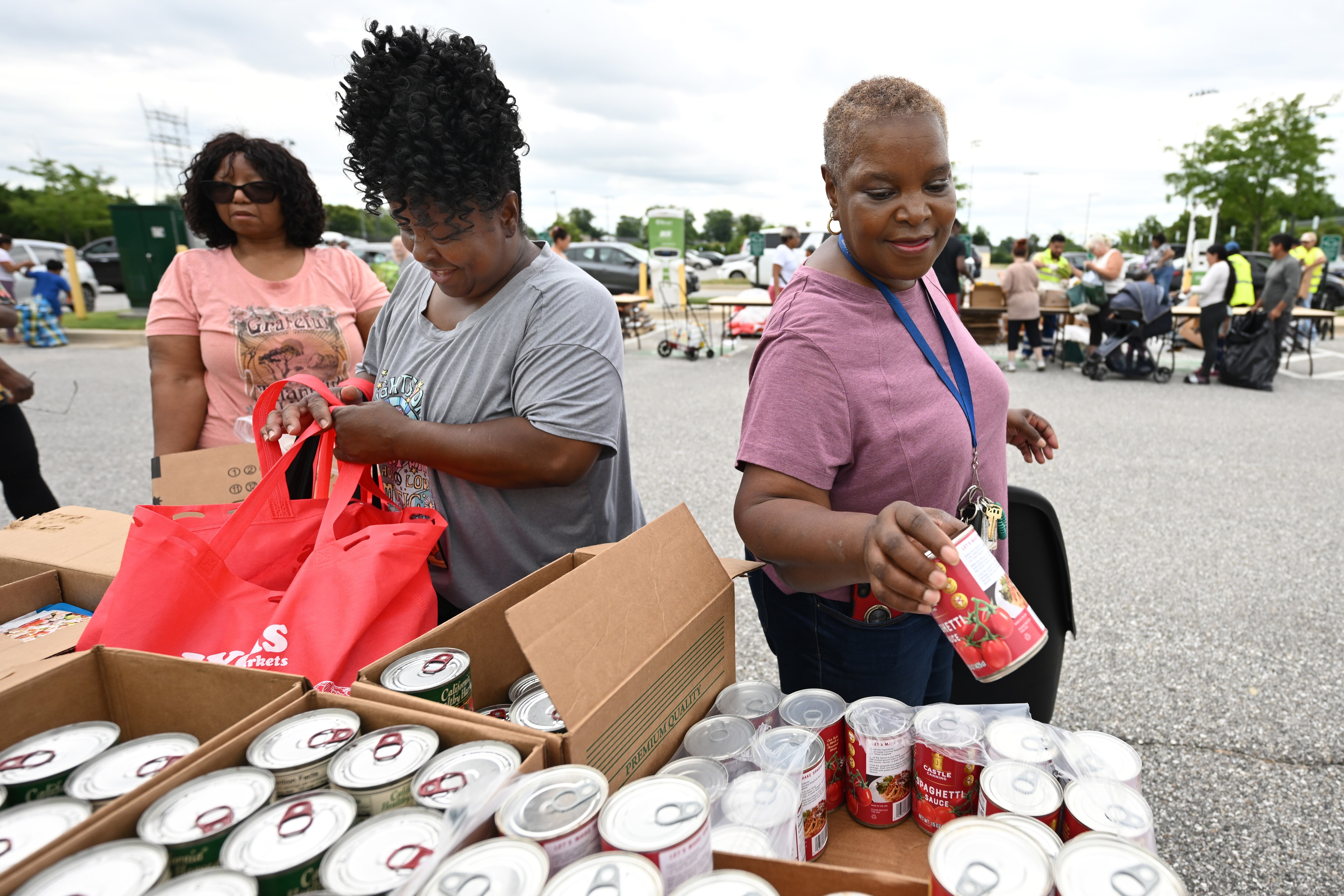 Venetia Barbee, left, and Tina Baylor fill bags at a food pantry for the community and workers affected by the Key Bridge collapse Saturday, July 13, 2024 in Dundalk Md.