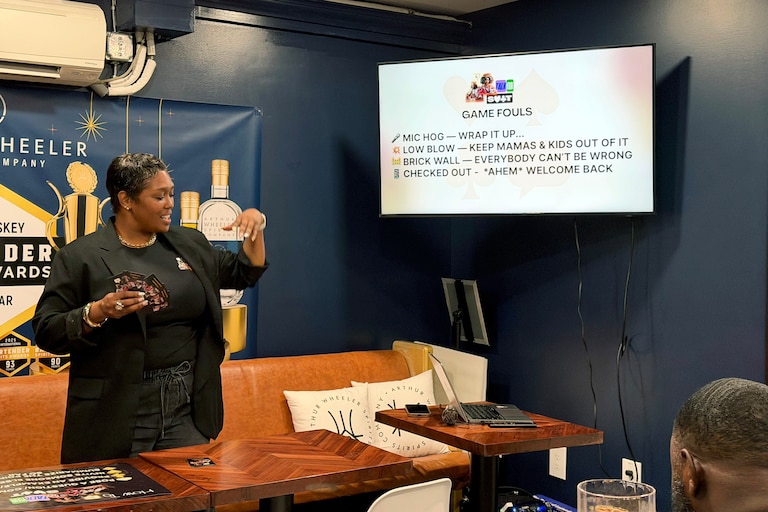 Cortnie Burriss hosts a game night every first Thursday of the month at Upper Marlboro’s Free State Distillery. Patrons play “Talk Your Suit,” a game Burriss originally created for her high school literature students and encourages players to use different conversation skills.