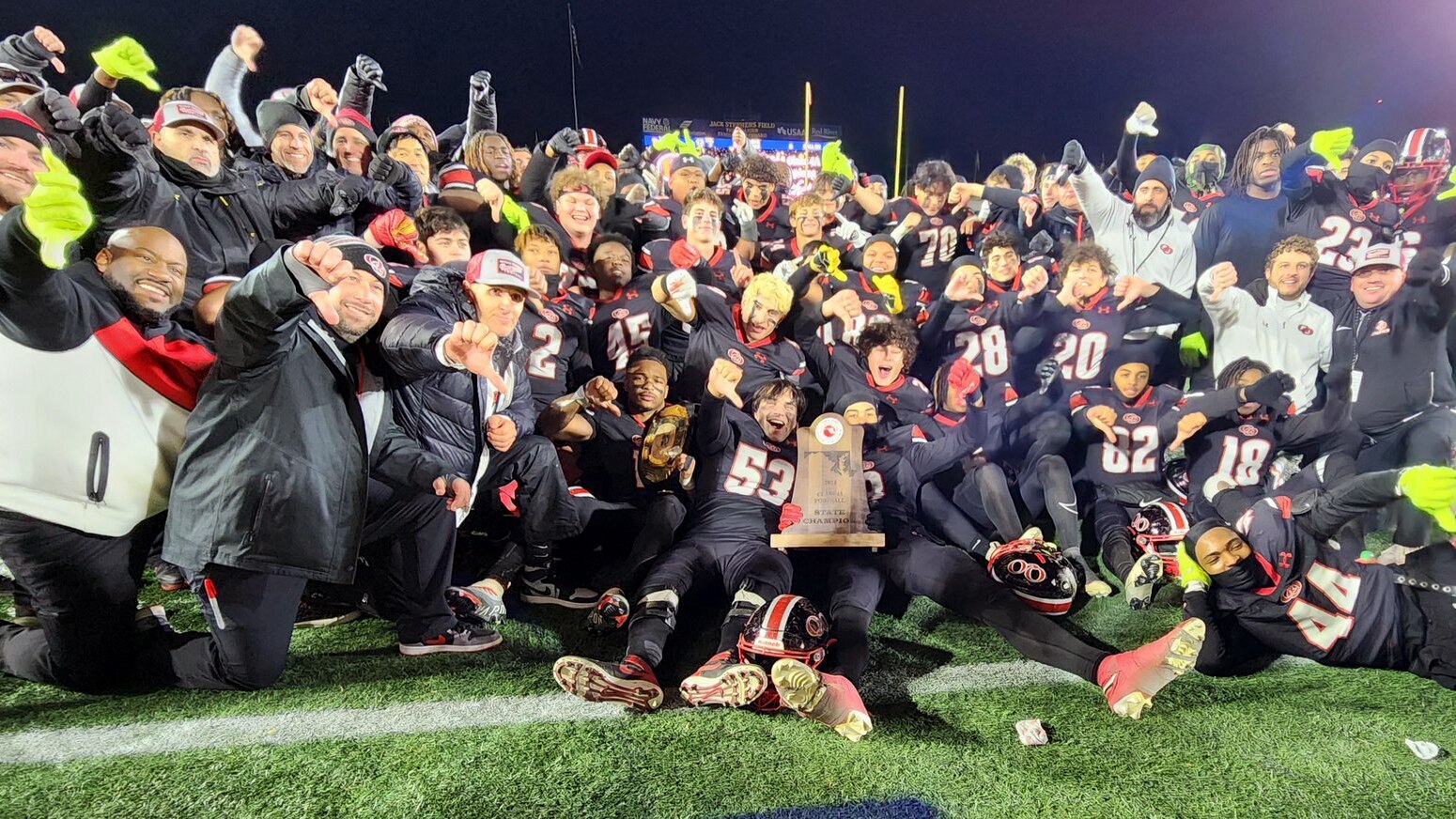 The Quince Orchard high school football team celebrates after winning the state championship last year.