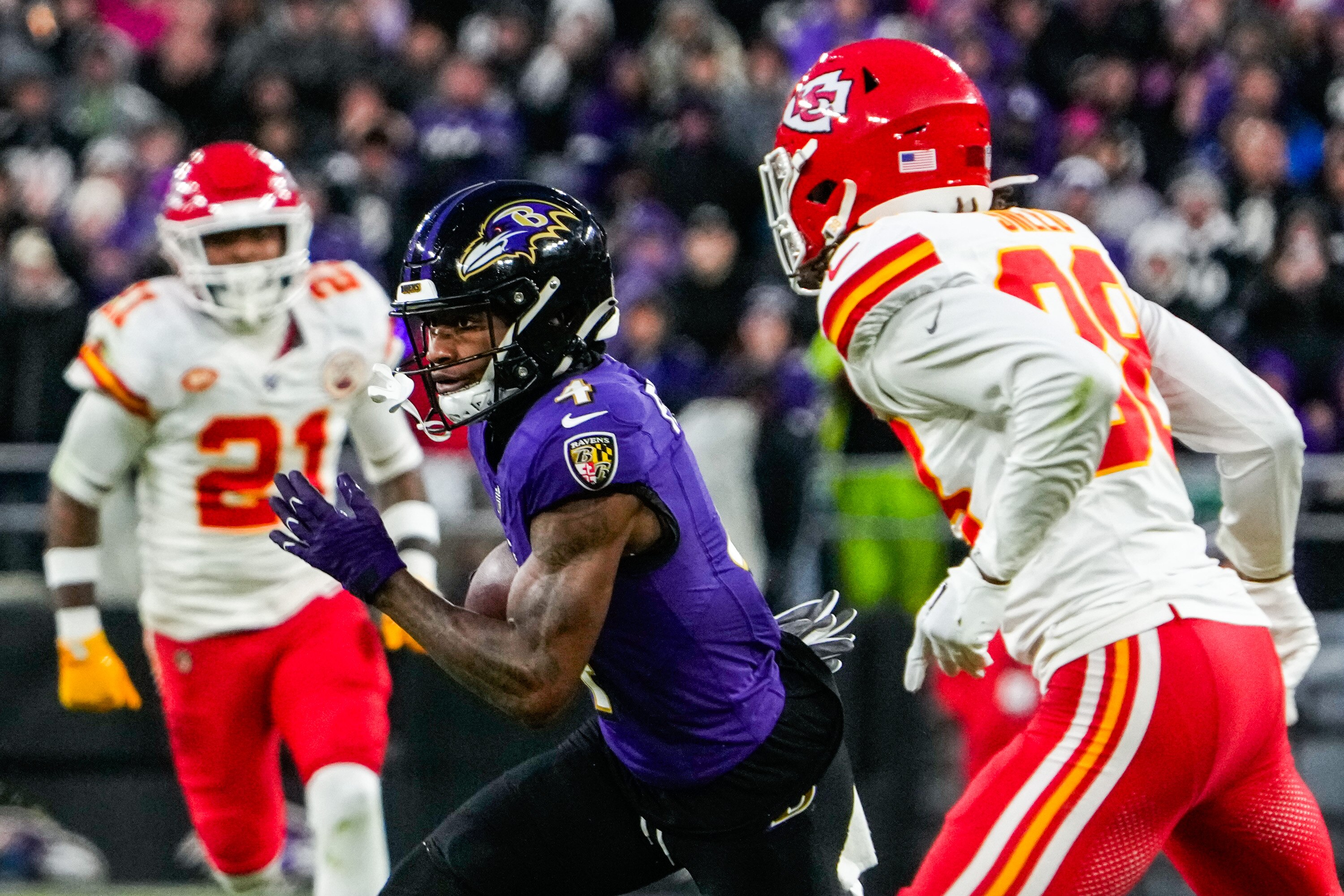 Ravens wide receiver Zay Flowers zips between a pair of Chiefs defenders during the AFC championship game. The Chiefs, who won that game and the Super Bowl, appear to be the toughest opponent on the Ravens’ schedule.