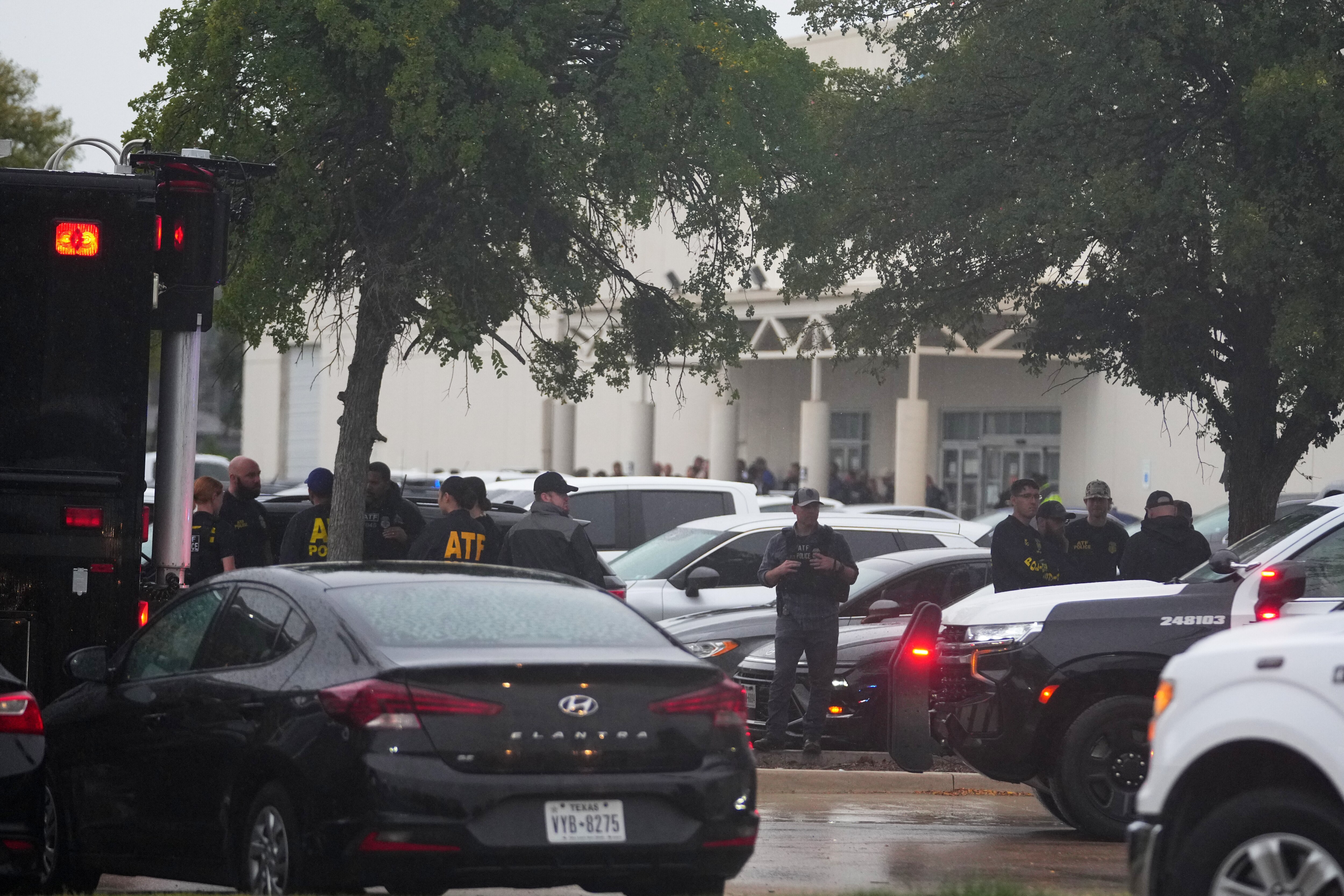 Law enforcement gather at a staging area close to a U.S. Immigration and Customs Enforcement office after a reported shooting, in Dallas on Wednesday, Sept. 24, 2025. (AP Photo/Julio Cortez)