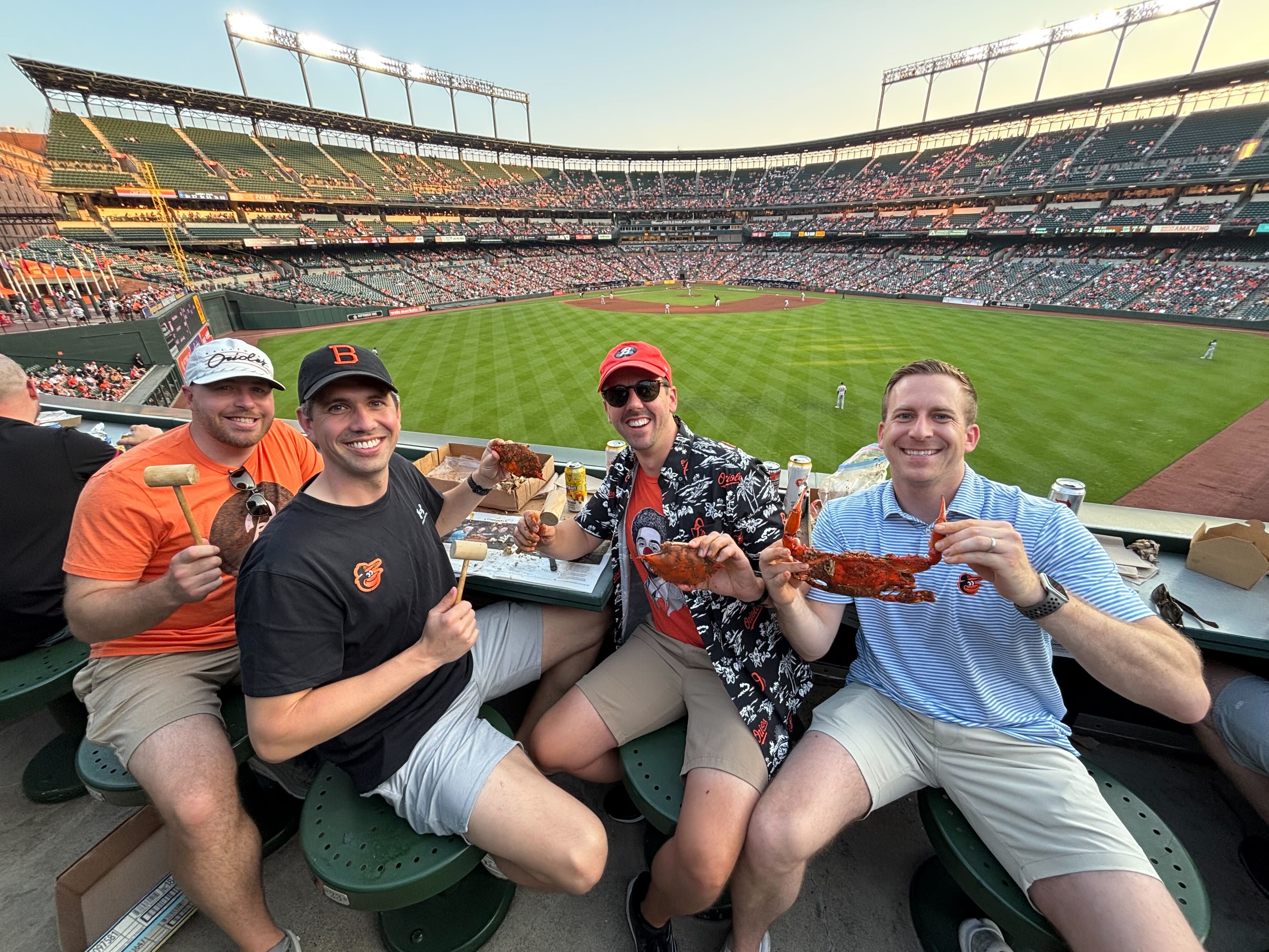 From left to right, Eric, Kelly, Dustin and Colby enjoy crabs from the center field roof deck at Camden Yards on Wednesday, June 11, 2025.