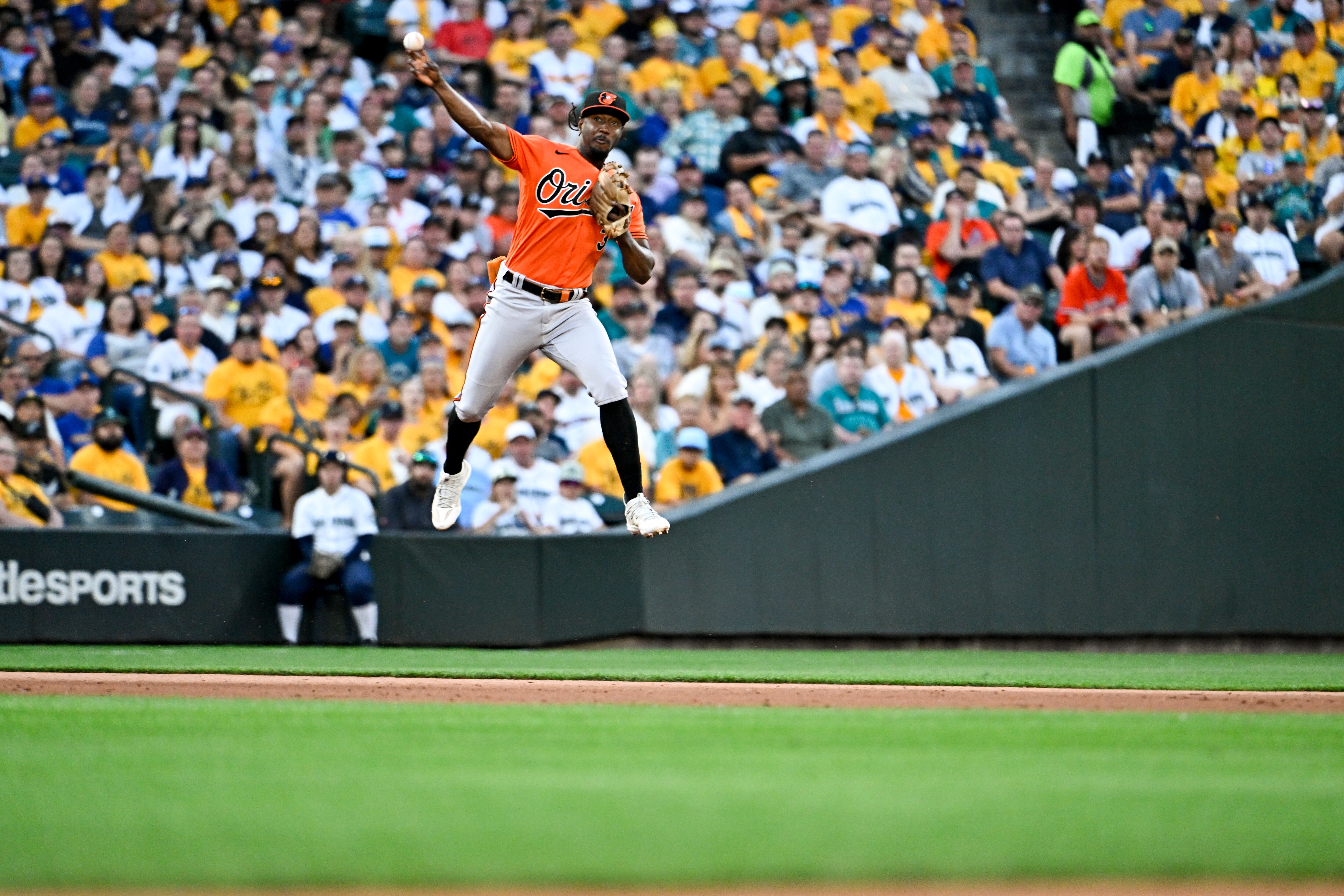 The Orioles' Jorge Mateo makes a leaping throw to first base during the sixth inning Saturday night in Seattle.