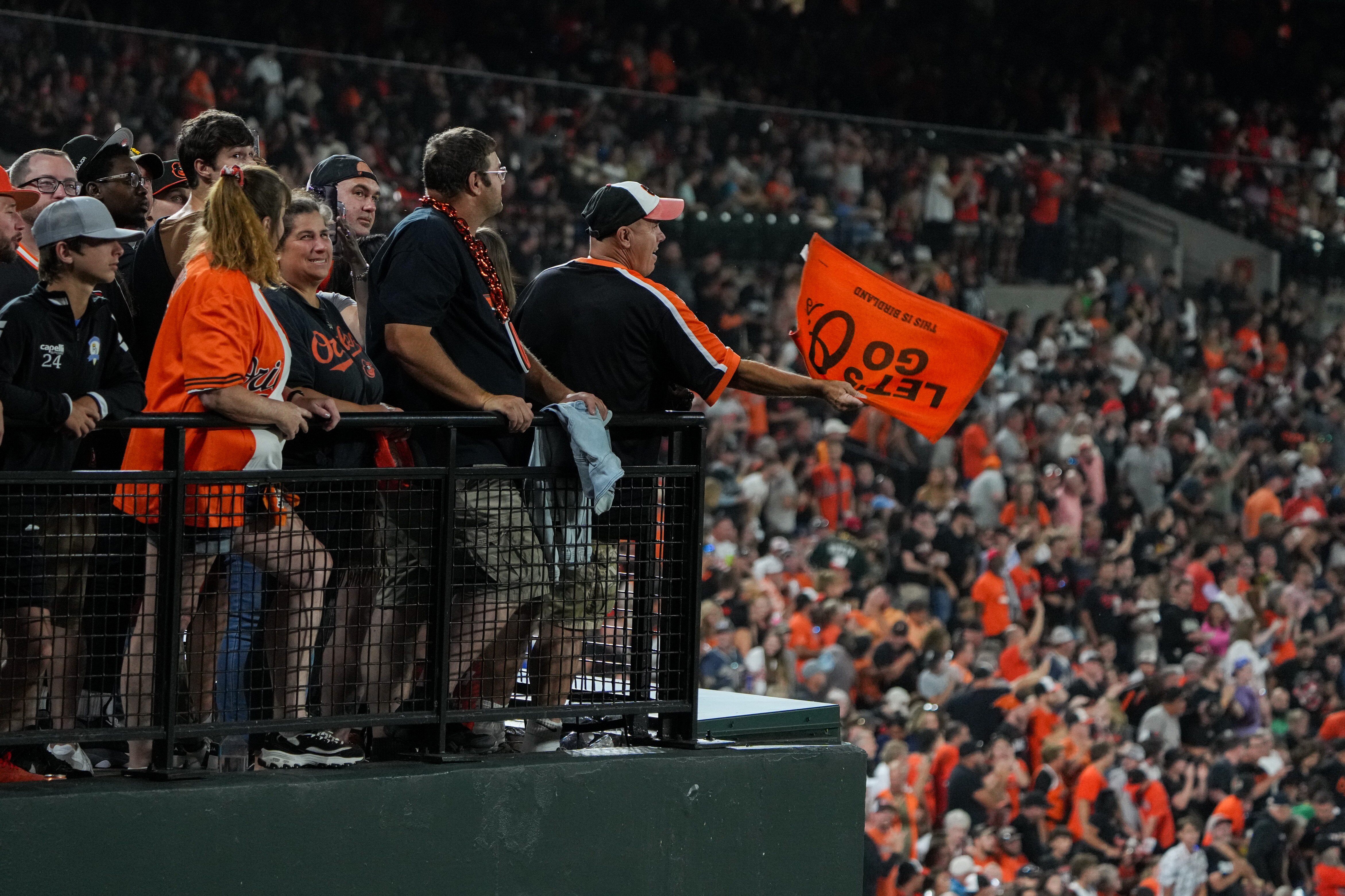 Orioles fans cheer from the flag court during the team's 8-0 win over Tampa Bay on Saturday night at Camden Yards.