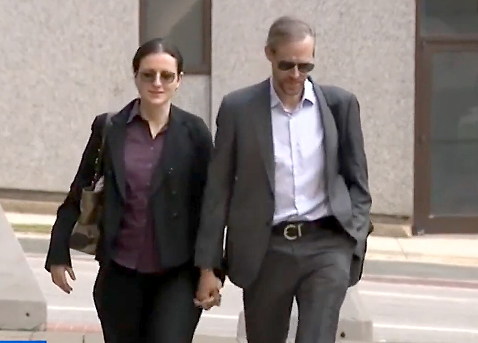 Anna Gabrielian, a former anesthesiologist at Johns Hopkins Hospital, and her spouse, U.S. Army Maj. Jamie Lee Henry, walk into the Edward A. Garmatz U.S. Courthouse in Baltimore on Tuesday, May 23, 2023.