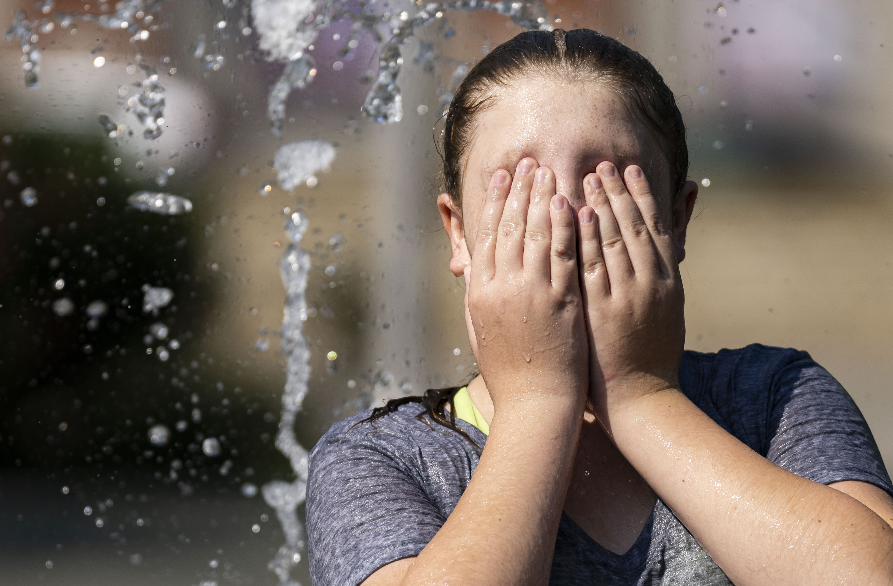 Nevaeh Stimak, 13, of Ohio, plays at the splash pad at West Shore Park in Baltimore, Wednesday, Sept. 6, 2023.