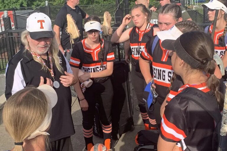 Rising Sun coach Paul Taylor (left) talks to his team after last year's Class 2A state softball championship game. The No. 6 Tigers claimed the UCBAC Chesapeake crown Monday with a 2-1 victory over 12th-ranked Patterson Mill in Harford County.