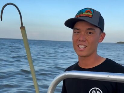 Baltimore crabber and social media influencer Luke McFadden with his hook, which he uses to fish items from rivers and the Chesapeake Bay. (Screen shot from TikTok)
