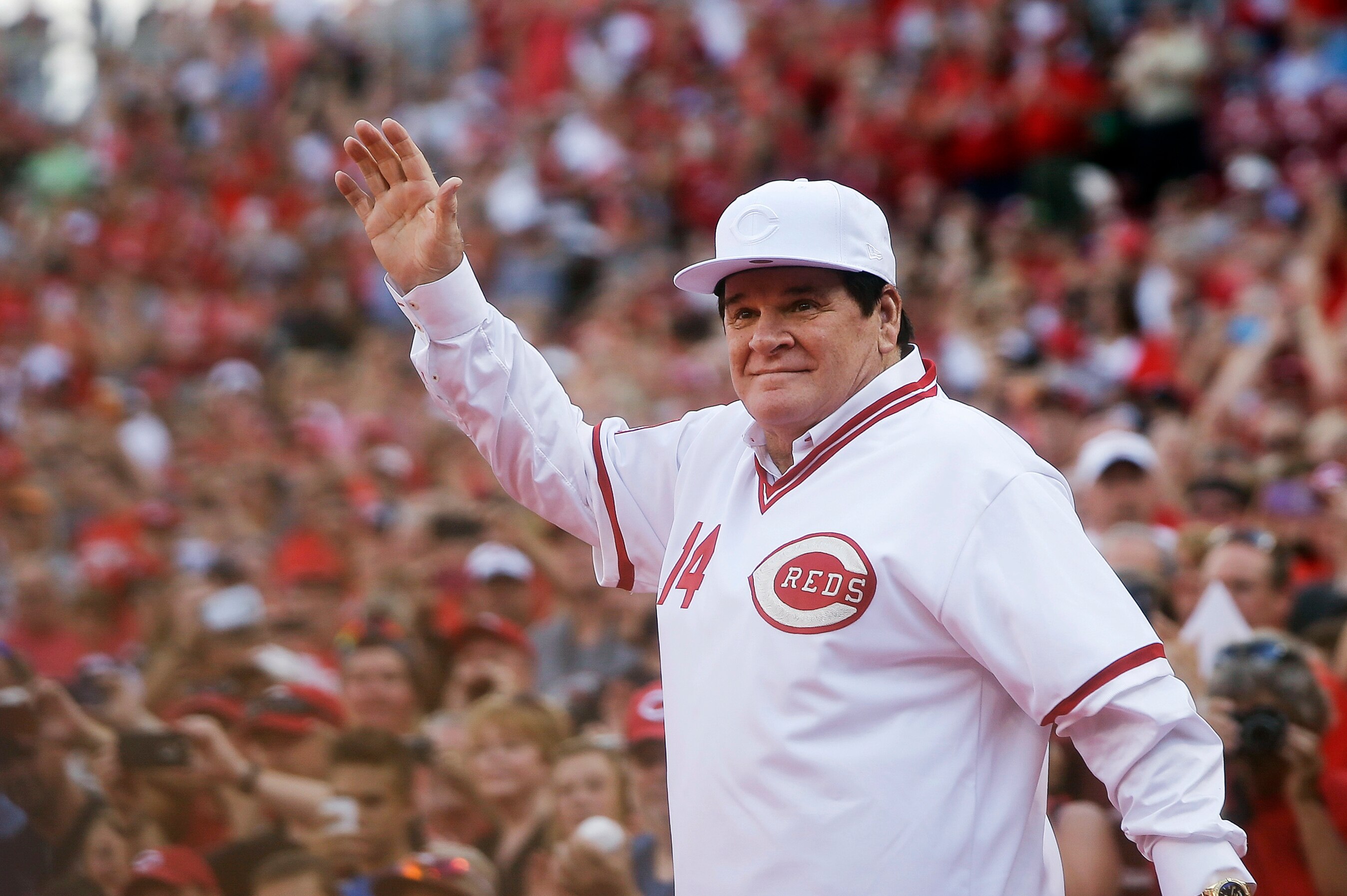 Former Cincinnati Red Pete Rose waves to the crowd as he is introduced on the field during a ceremony to honor the 1976 World Series champions team, before a 2016 game.