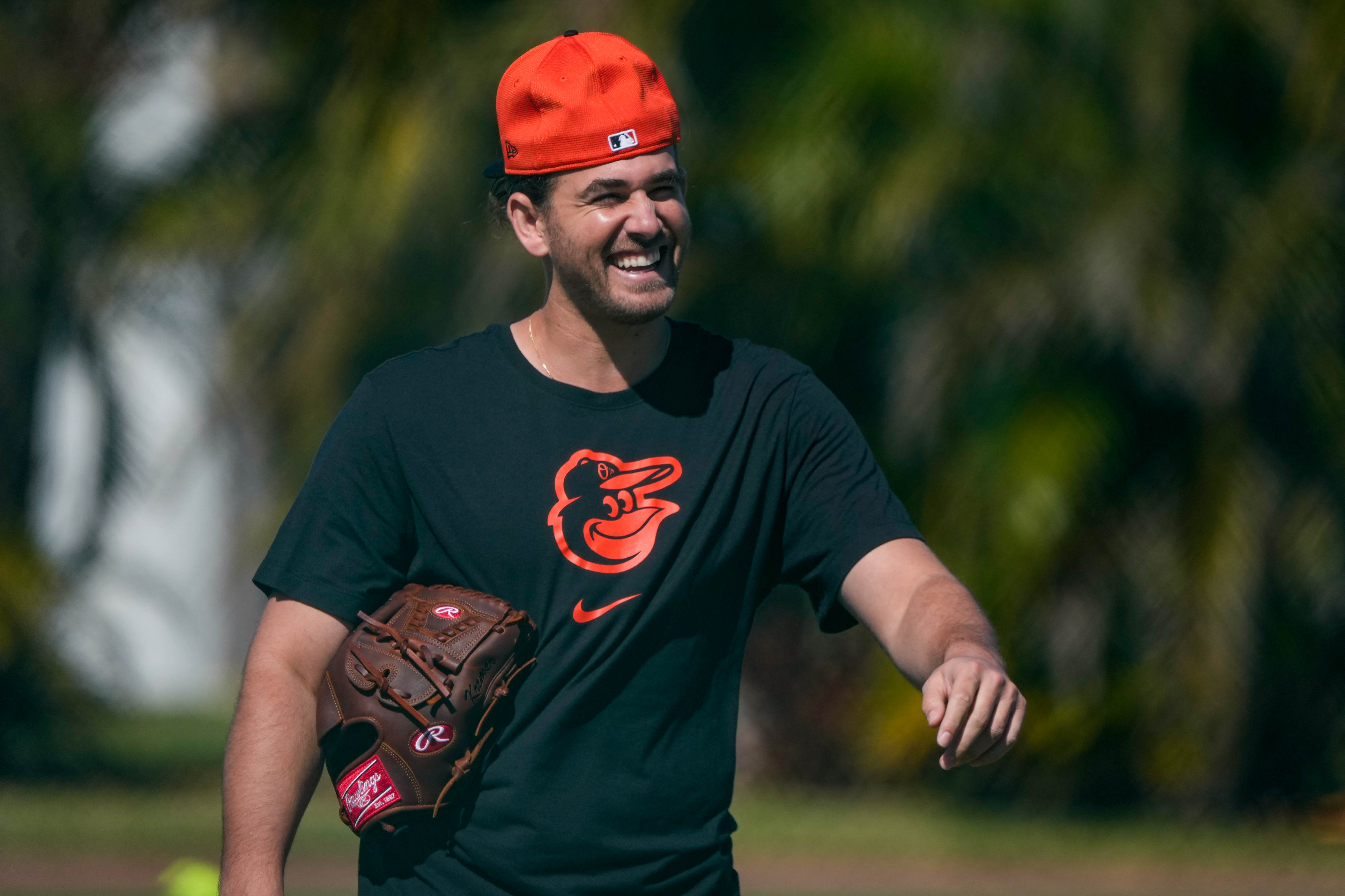 Baltimore Orioles pitcher Dean Kremer laughs with teammates while walking to the backfields during spring training last month.