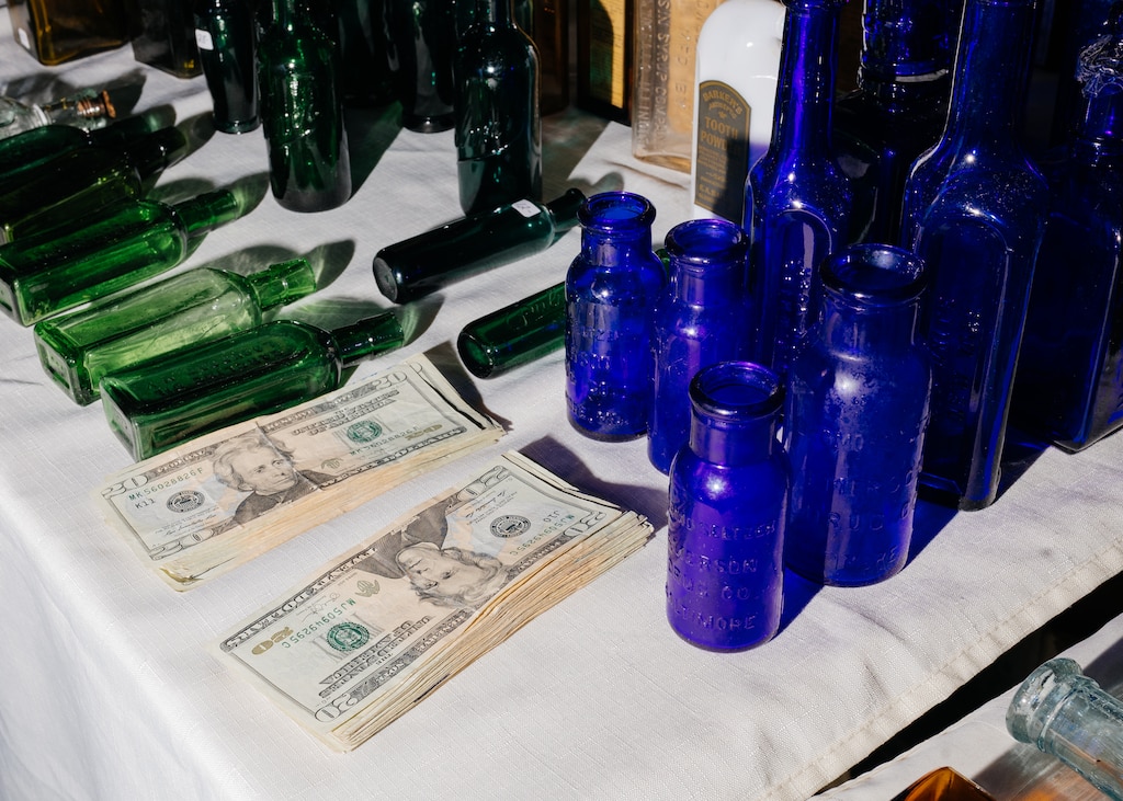 Stacks of cash are prepared on a vendor table for a sale at The Baltimore Antique Bottle Club 45th Annual Show & Sale at the Howard County Fair Grounds