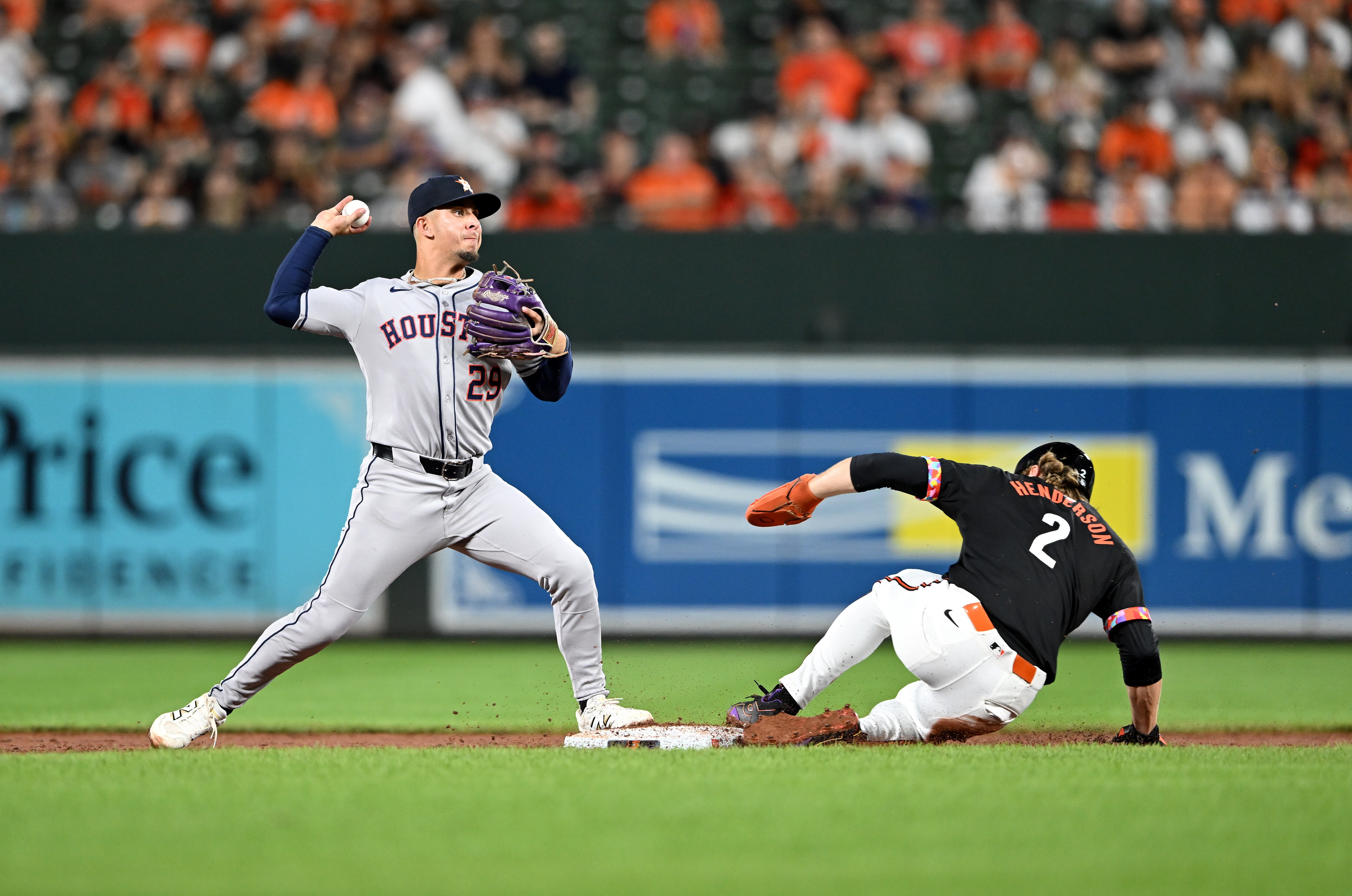 Ramón Urías of the Astros forces out Gunnar Henderson to start a double play in the third inning Friday night at Camden Yards.