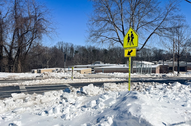 An ice-covered crosswalk in Rockville shows the road conditions that Montgomery County Public Schools are evaluating before deciding to open campuses
