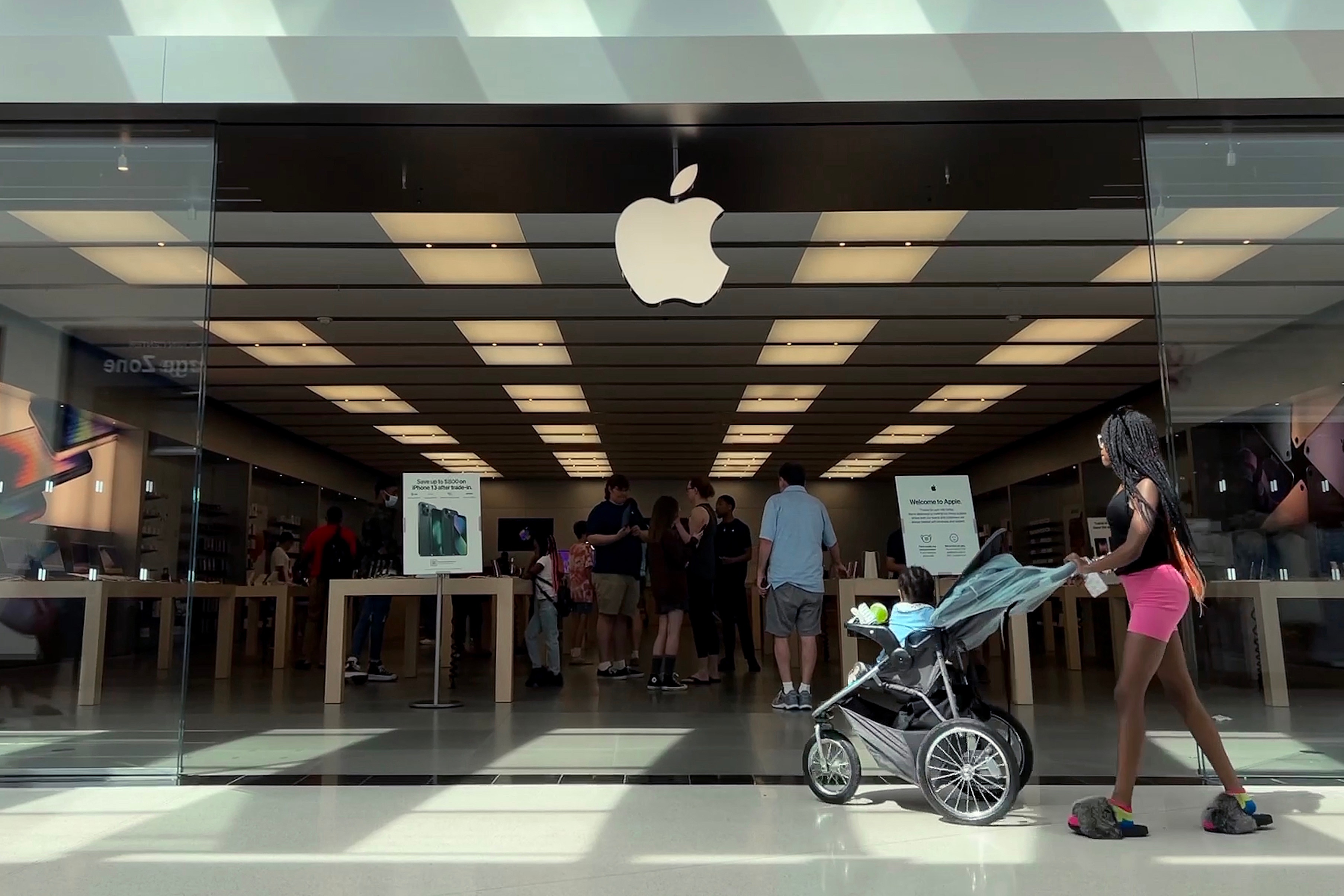 TOWSON, MARYLAND - JUNE 20: Customers shop at The Apple Store at the Towson Town Center mall, the first of the company's retail locations in the U.S. where workers voted over the weekend to unionize, on June 20, 2022 in Towson, Maryland. Following a late-pandemic era wave of workers demanding higher pay,  better benefits and more negotiating leverage, 65 of the 98 workers at the Towson Apple Store voted to join the International Association of Machinists and Aerospace Workers union on June 18.