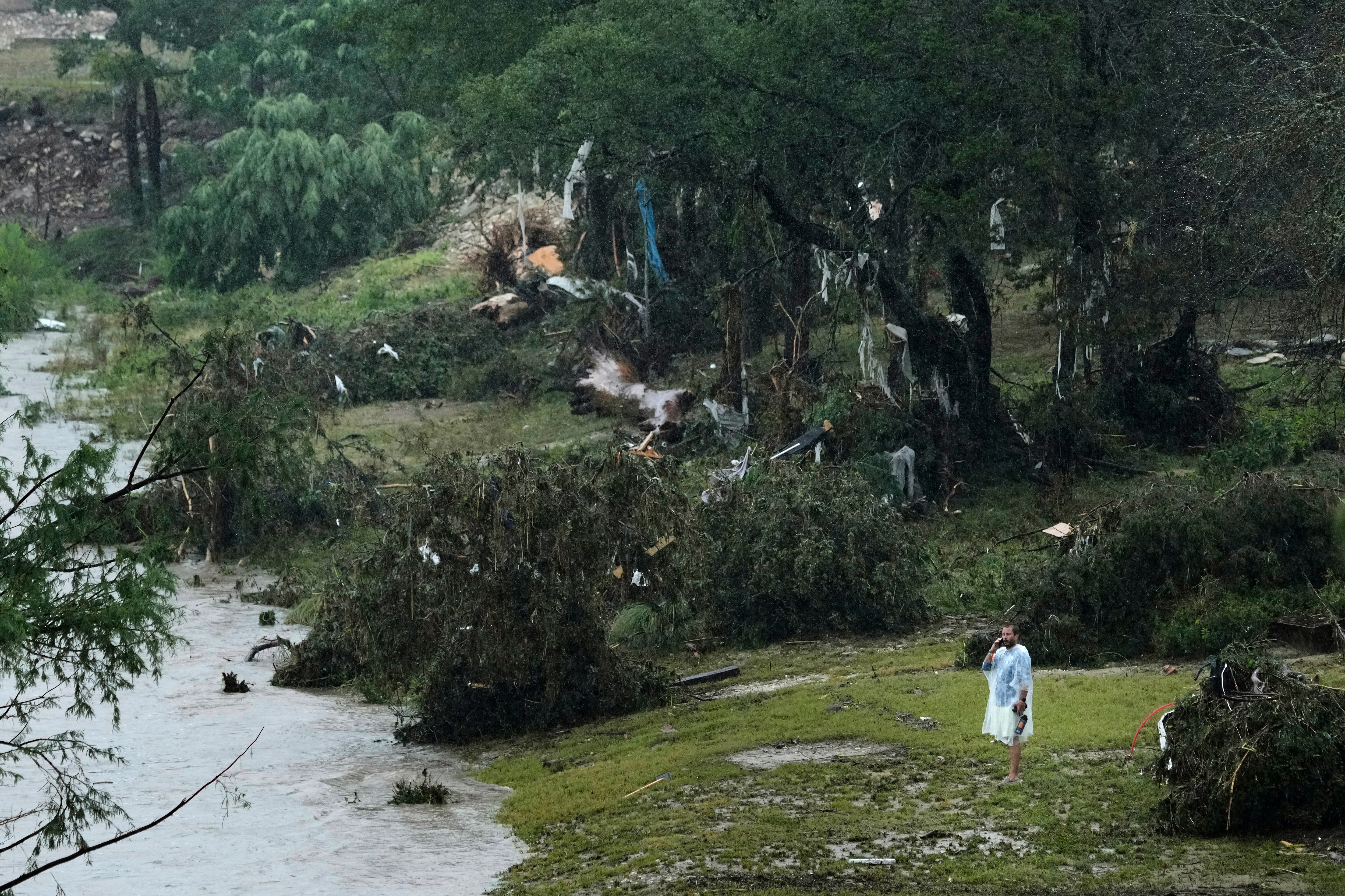 A man surveys damage left by a raging Guadalupe River, Friday, July 4, 2025, in Kerrville, Texas.