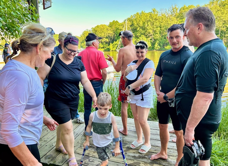 Amy Clements of the Spa Creek Conservancy, left, and I, right, talk with swimmers and well-wishers on the dock at Amos Garrett Park.