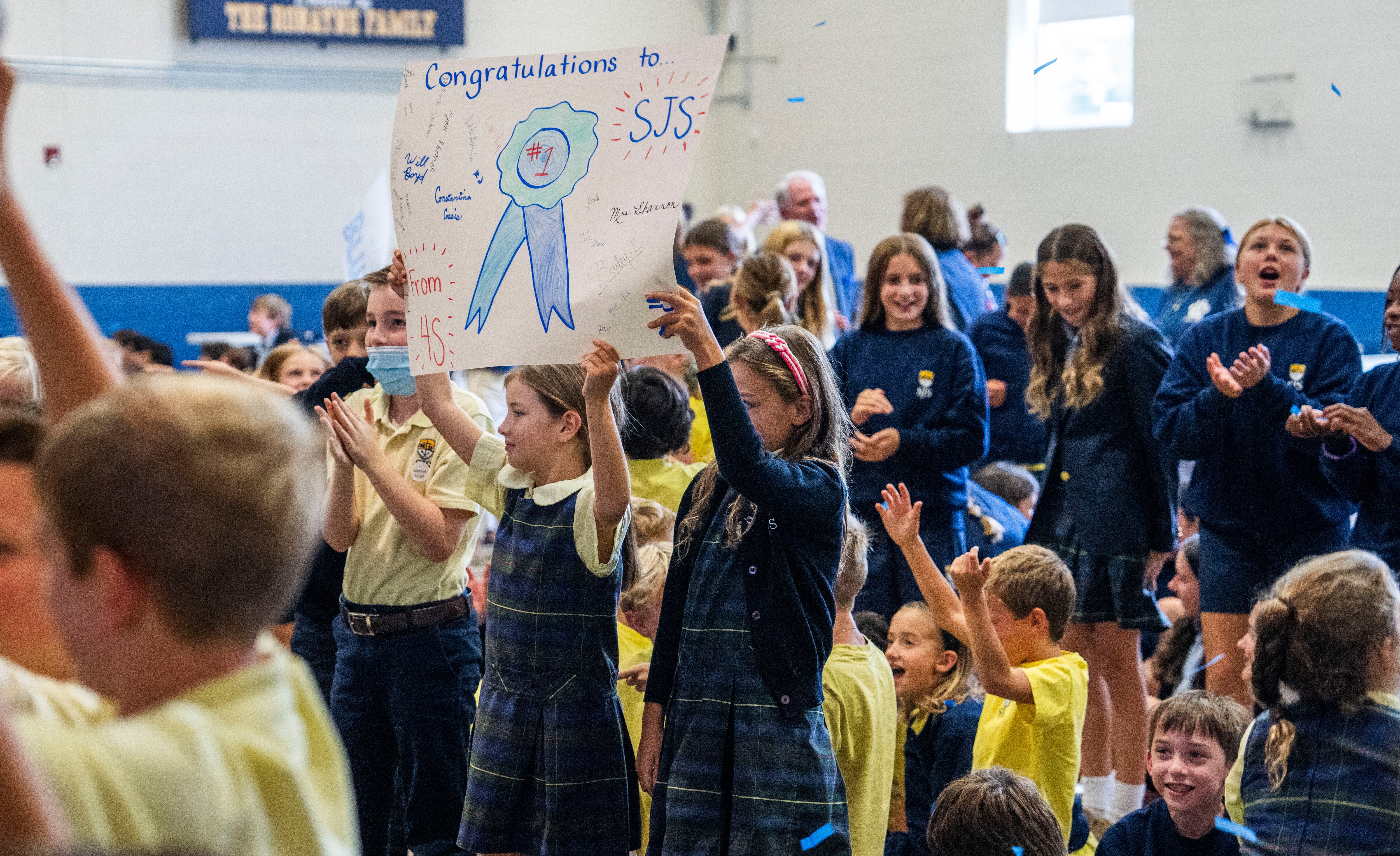 Students at St Joseph School celebrated their Blue Ribbon win with cheers, signs and confetti on Sept. 23, 2024. The U.S. Department of Education ended the national program this year.