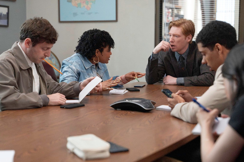 THE PAPER -- Episode 102 -- Pictured: (l-r) Alex Edelman as Adam, Gbemisola Ikumelo as Adelola, Domhnall Gleeson as Ned, Melvin Gregg as Detrick -- (Photo by: Aaron Epstein/PEACOCK)