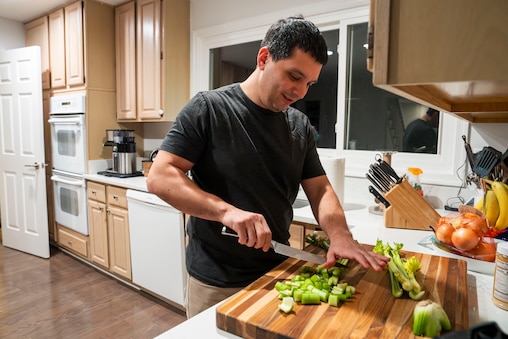 Matt Newman demonstrates his sharpened knives in action in his home on November 22, 2023.