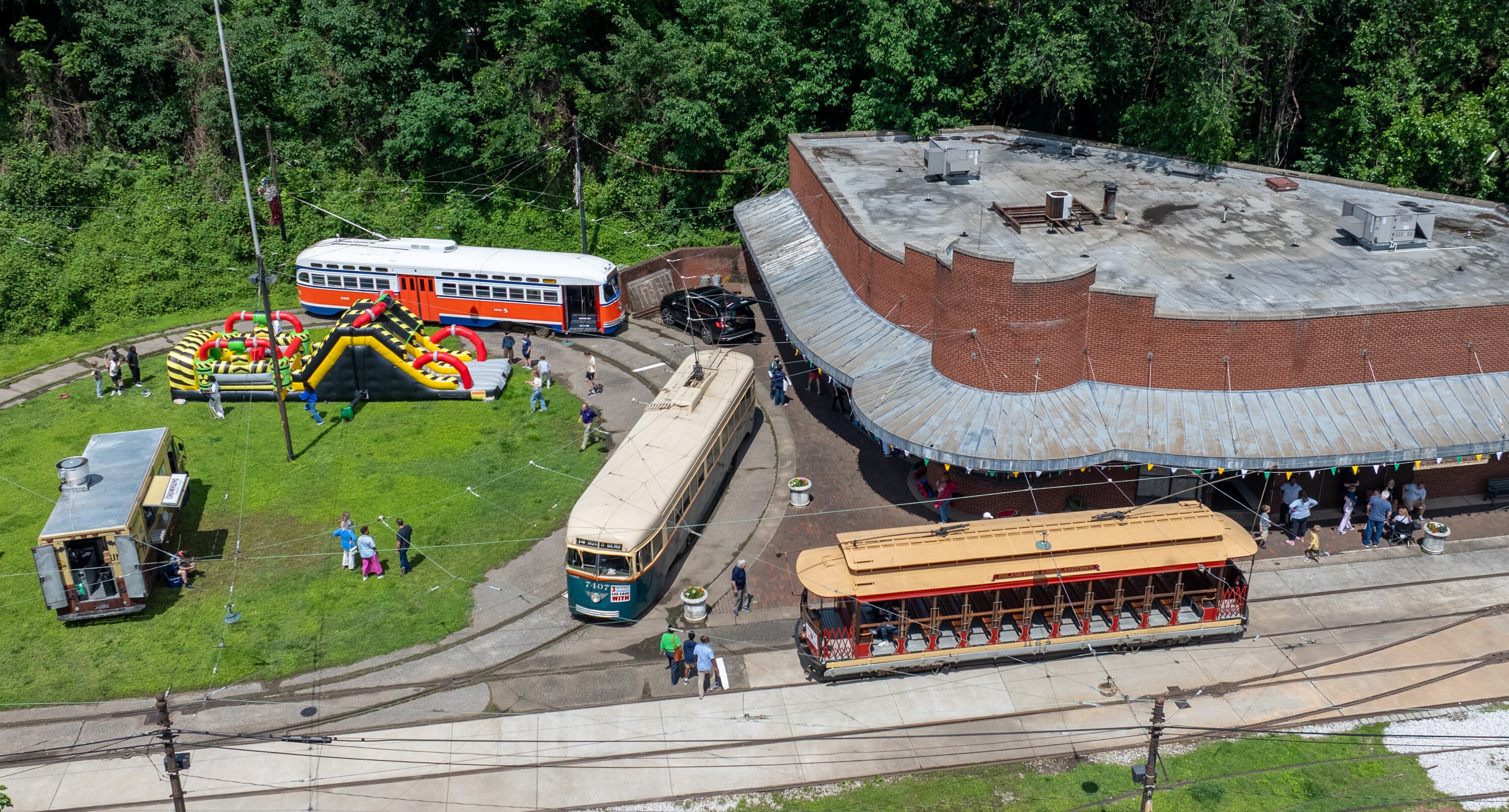 Streetcars from different eras are displayed during an event at the Baltimore Streetcar Museum.