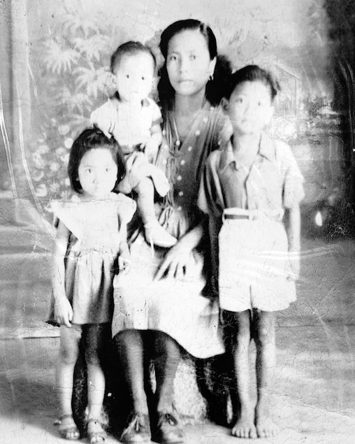 Paul Torres, right, as a child with his his mother and siblings.