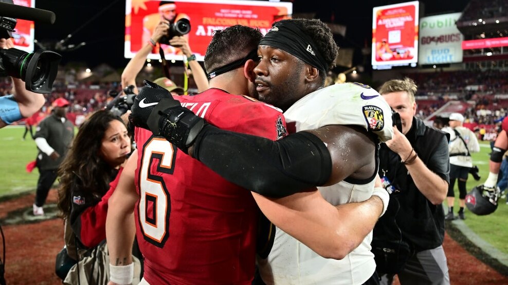 TAMPA, FLORIDA - OCTOBER 21: Baker Mayfield #6 of the Tampa Bay Buccaneers hugs Roquan Smith #0 of the Baltimore Ravens following the game at Raymond James Stadium on October 21, 2024 in Tampa, Florida. Baltimore defeated Tampa Bay 41-31. (Photo by Julio Aguilar/Getty Images)