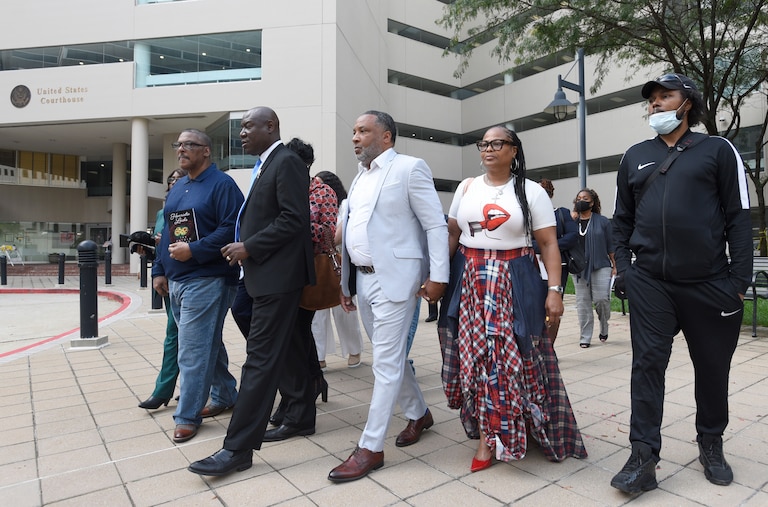 FILE - Attorney Ben Crump, second from left, walks with Ron Lacks, left, Alfred Lacks Carter, third from left, both grandsons of Henrietta Lacks, and other descendants of Lacks, outside the federal courthouse in Baltimore, Oct. 4, 2021. (AP Photo/Steve Ruark, File)