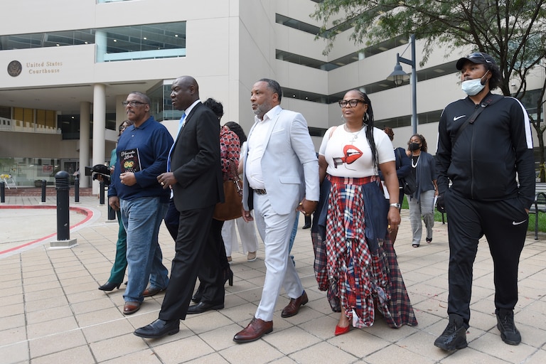 FILE - Attorney Ben Crump, second from left, walks with Ron Lacks, left, Alfred Lacks Carter, third from left, both grandsons of Henrietta Lacks, and other descendants of Lacks, outside the federal courthouse in Baltimore, Oct. 4, 2021. (AP Photo/Steve Ruark, File)