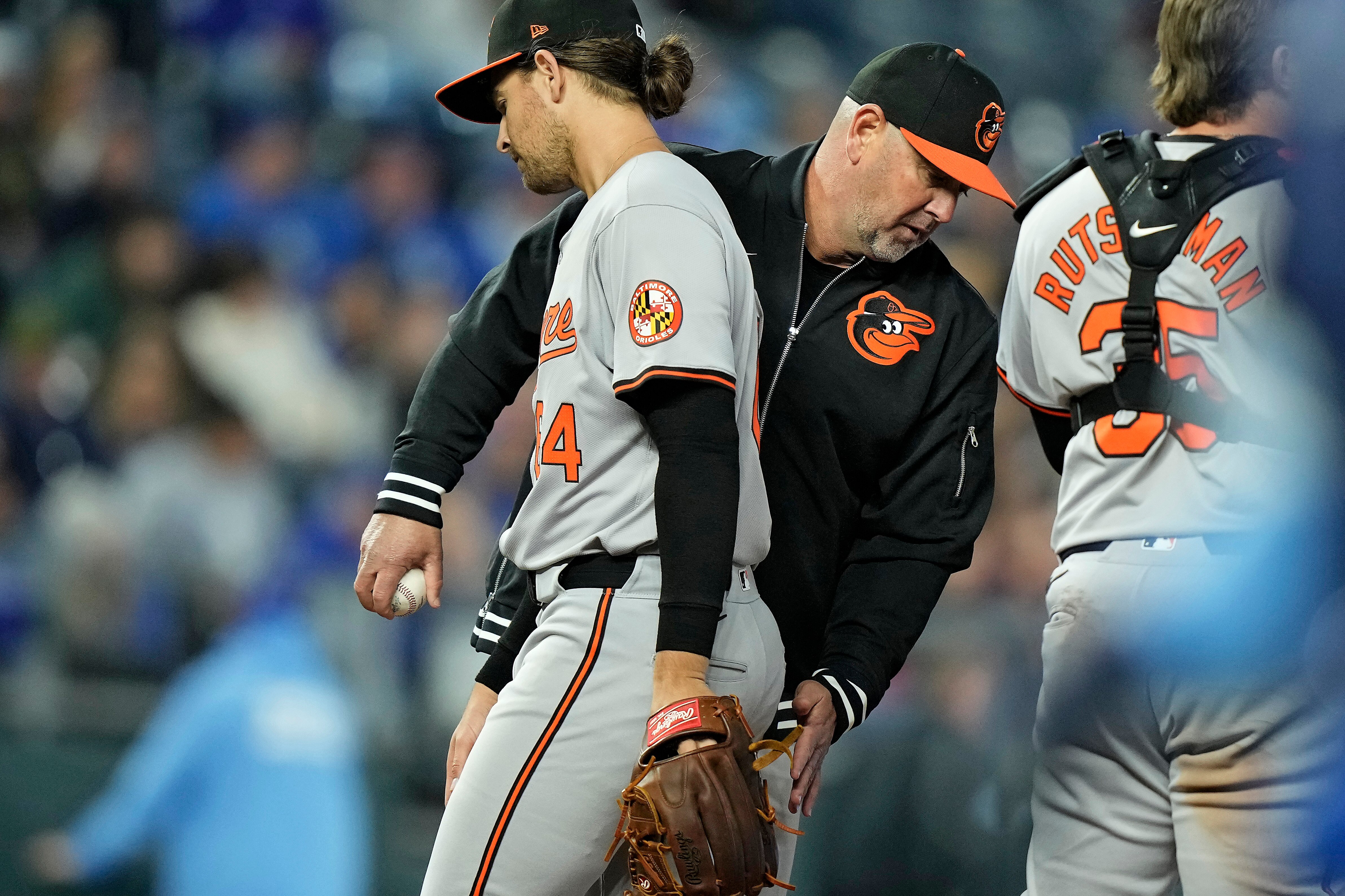 Orioles manager Brandon Hyde sends starting pitcher Dean Kremer to the dugout during the sixth inning Friday night in Kansas City.