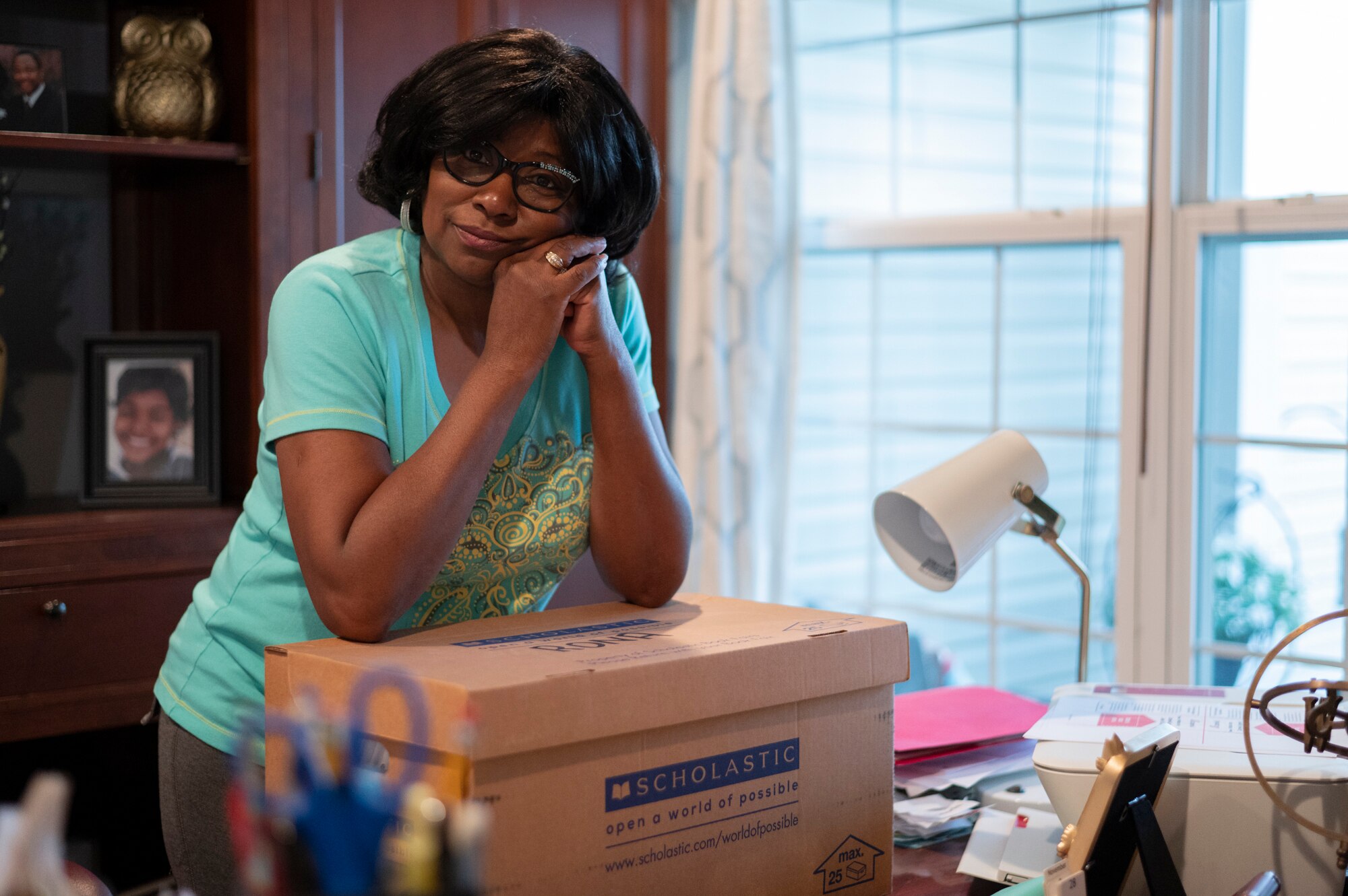 Jayne Felton rests her arms on her box of paperwork related to her sister’s care in her home office in Havre De Grace on June 8, 2023.