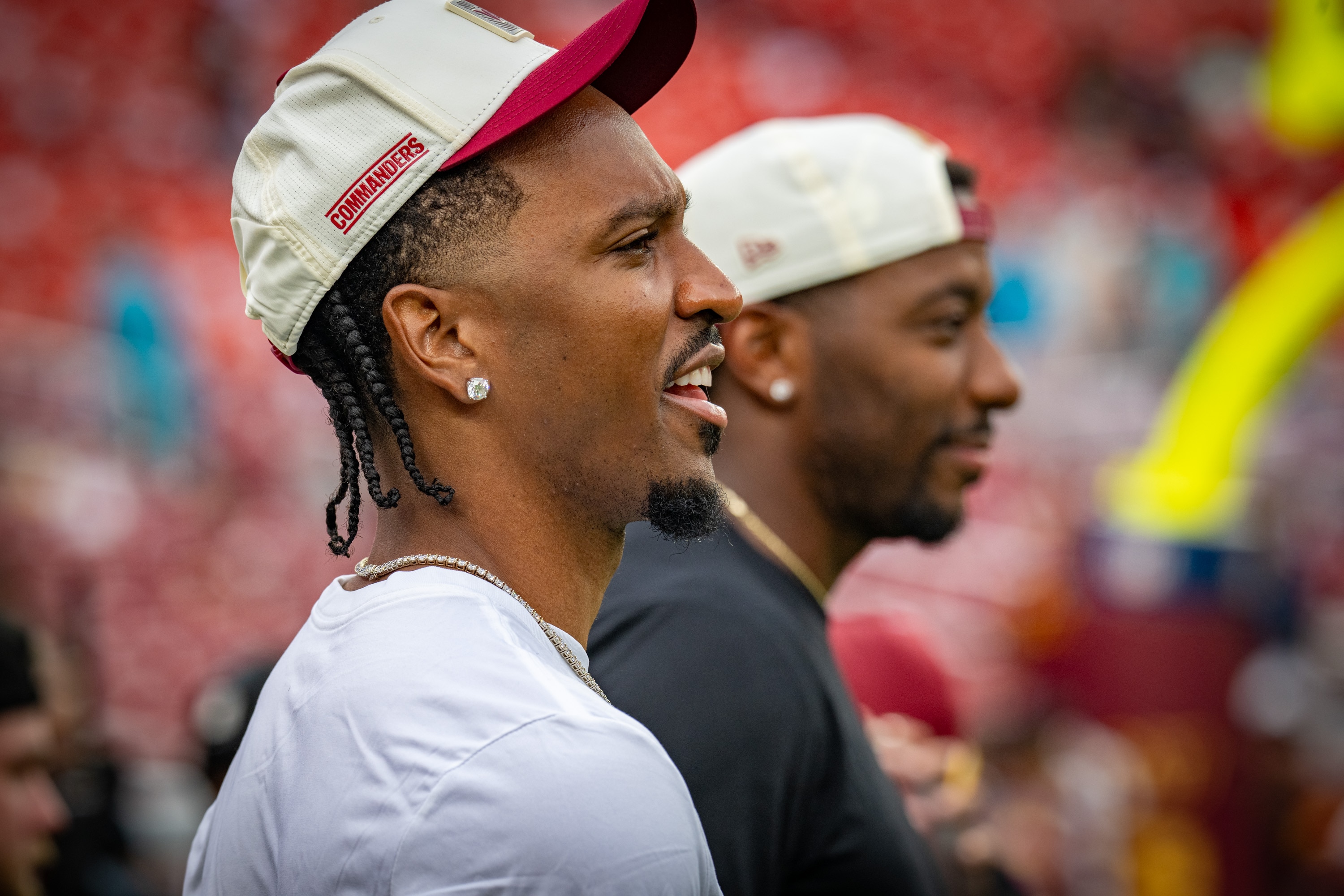 Washington Commanders quarterback Jayden Daniels watches warm-ups as the team prepares to host the Miami Dolphins in the preseason.