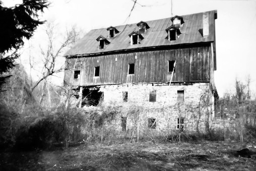 The gristmill in around 1985. It had been unoccupied for 25 years and was deteriorating when a group of volunteers formed the non-profit Friends of Jerusalem Mill to renovate the old Quaker village.