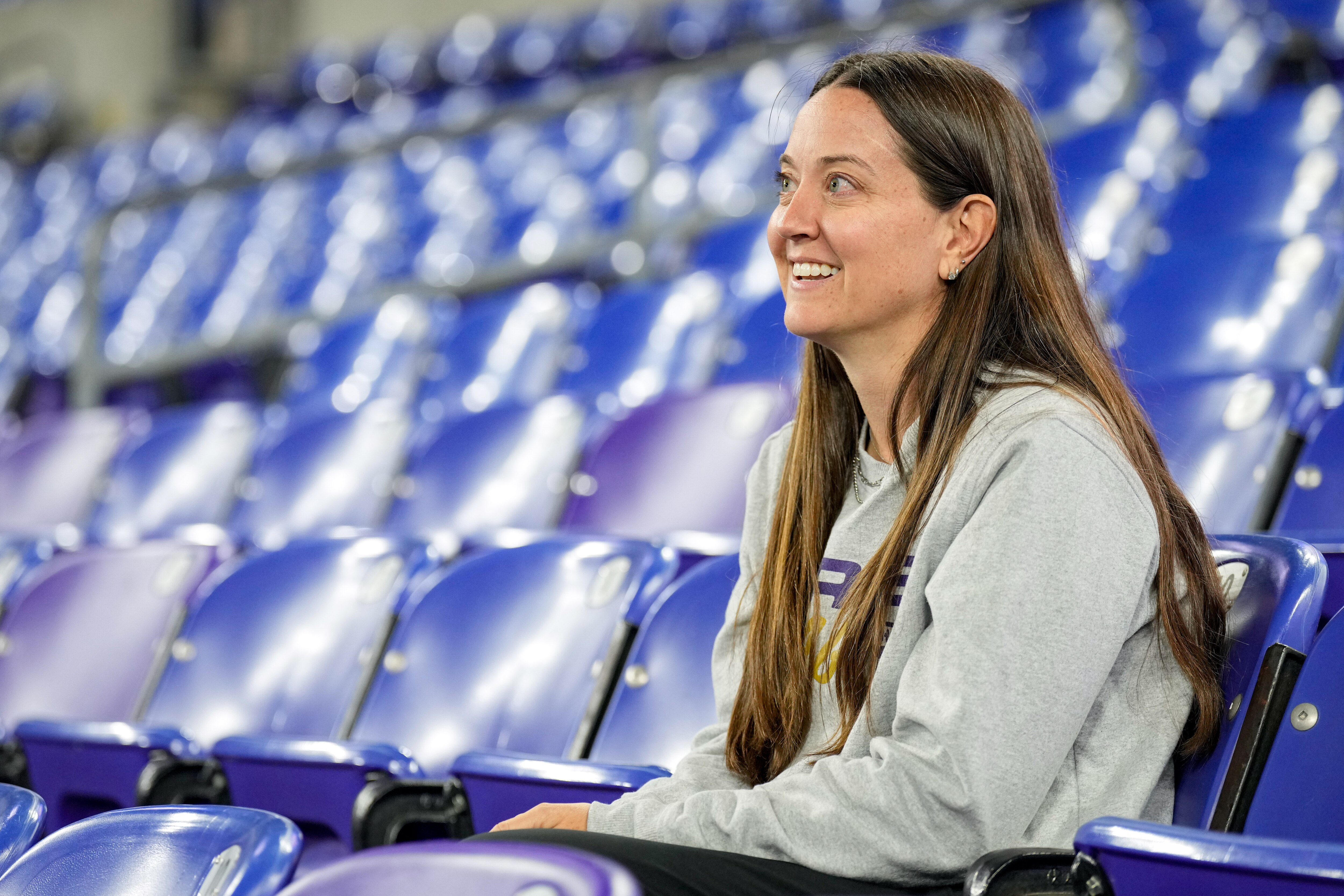 Kim Ferguson, the Baltimore Ravens’ Senior Director of Fan Development & Activation, watches the game action from the stands during the 2024 Maryland High School Girls Flag Football Championship at M&T Bank Stadium in Baltimore, Md., on Friday, November 8, 2024.