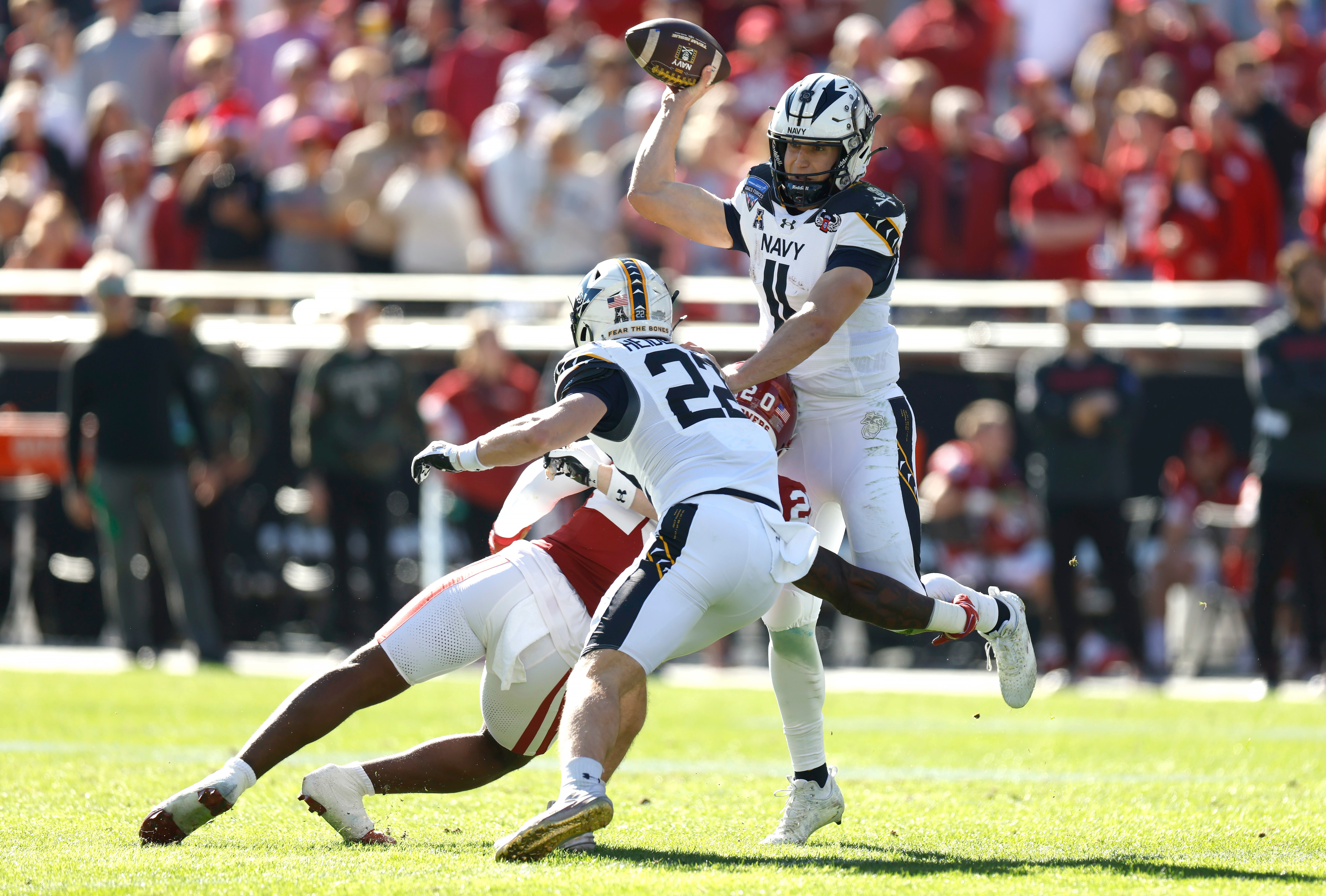 Navy quarterback Blake Horvath throws a pass under pressure Friday during the Midshipmen’s 21-20 win over Oklahoma in the Armed Forces Bowl.