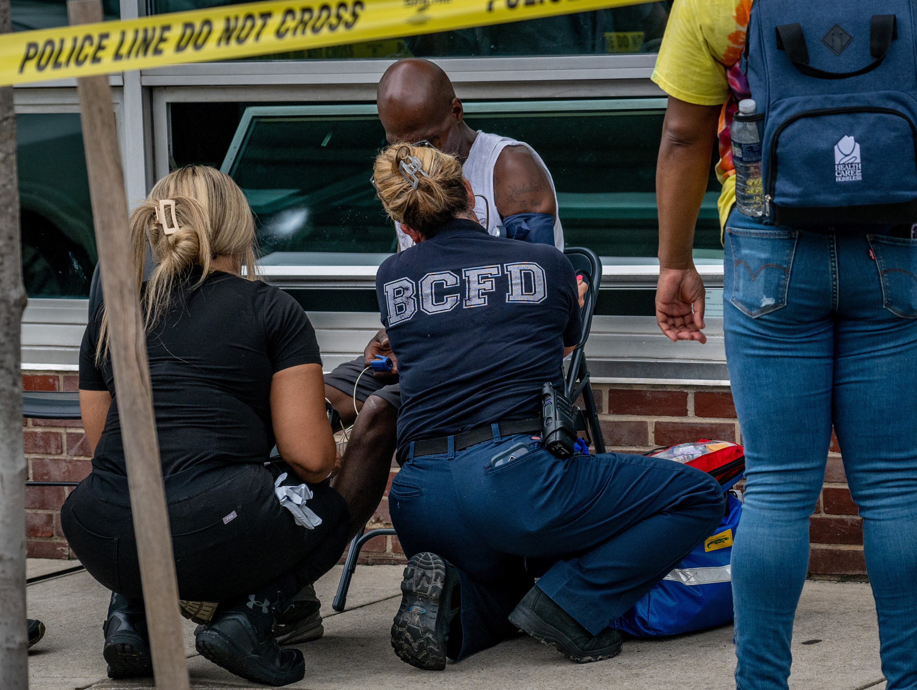 An person receives treatment in a triage area near Penn North metro station after Baltimore Police and Baltimore City Fire officials ⁩responded to a mass overdose call on Thursday.