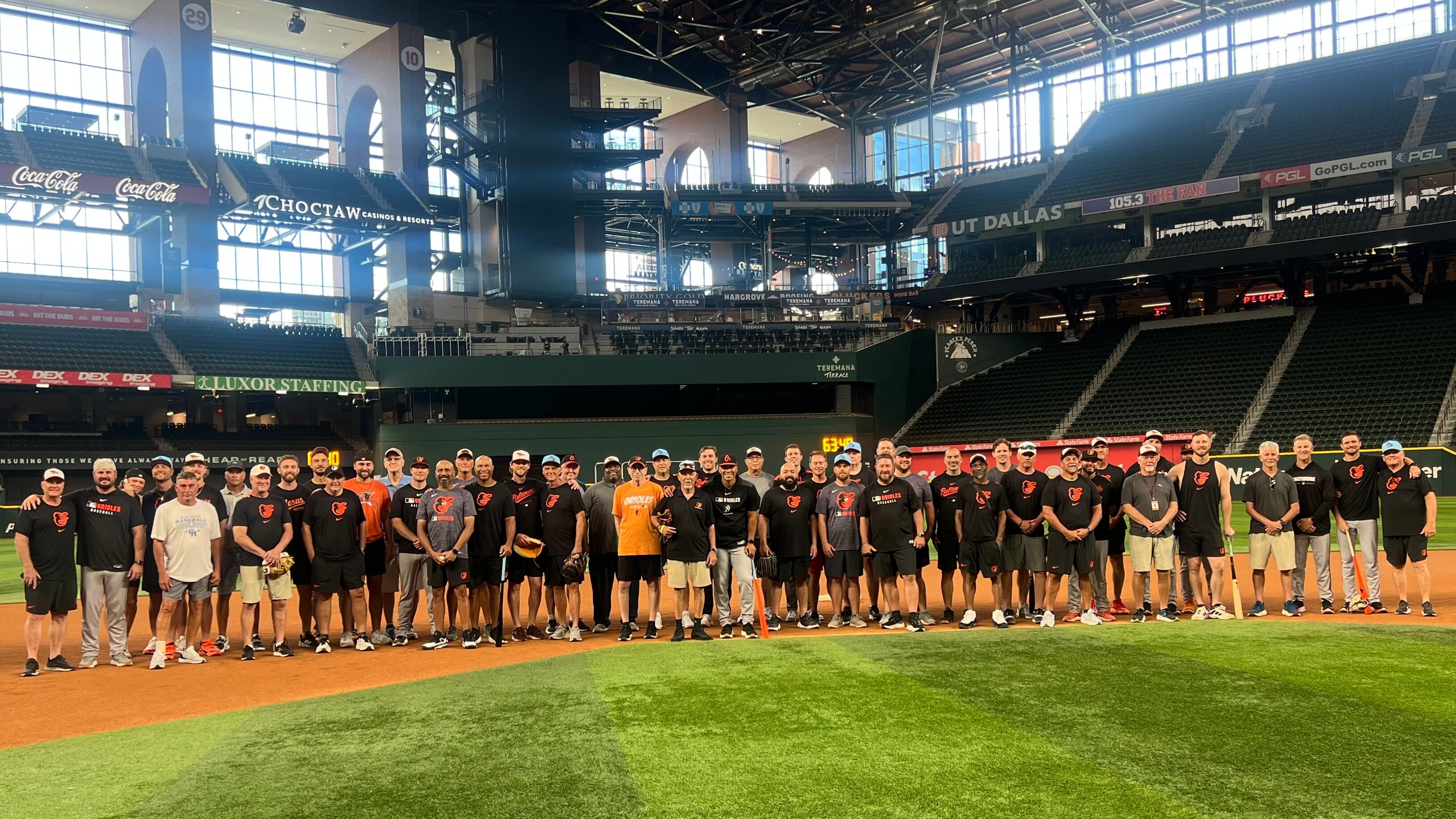 A large group of dads pose with their Orioles-playing sons during Baltimore's Dads Trip to Arlington, Texas, on Tuesday.