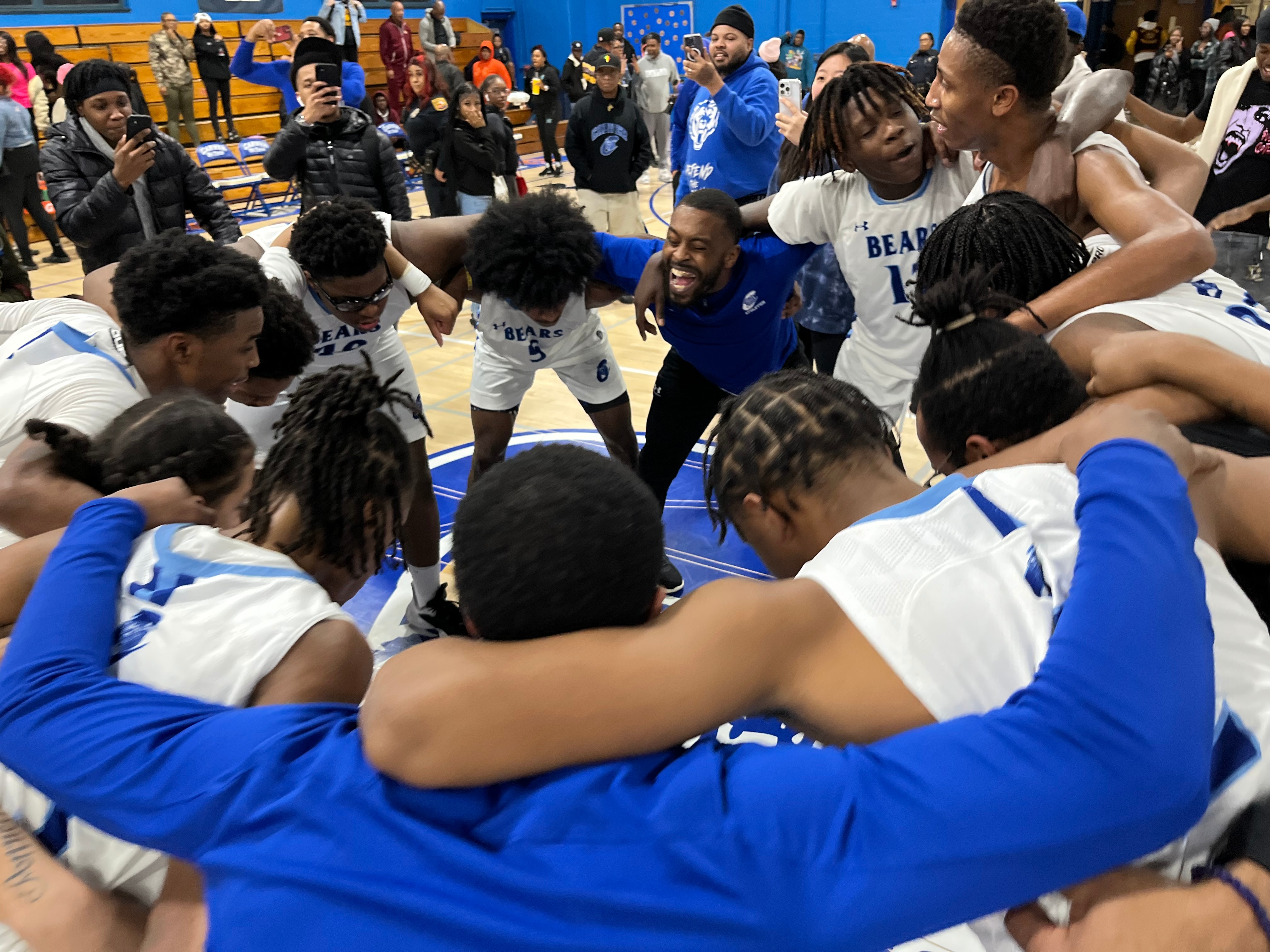 Carver Vo-Tech boys basketball celebrate after Tuesday's victory over Dunbar. The Bears defeated the Poets, 53-44, to advance Thursday's Class 2A North Region II championship game.