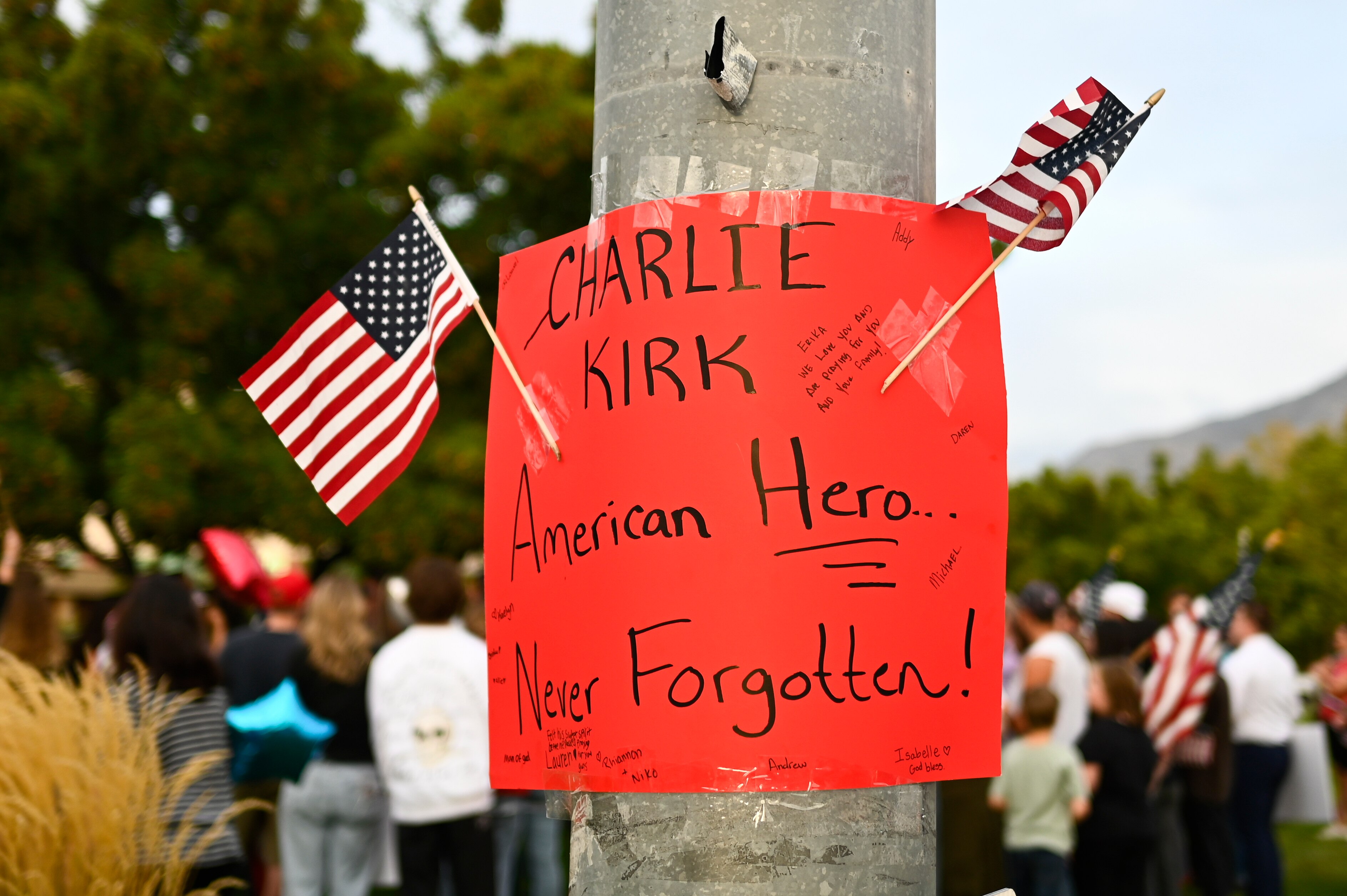 People attend a vigil for Charlie Kirk, the CEO and co-founder of Turning Point USA who was shot and killed earlier in the day, at Timpanogos Regional Hospital on Wednesday, Sept. 10, 2025, in Orem, Utah. (AP Photo/Alex Goodlett)