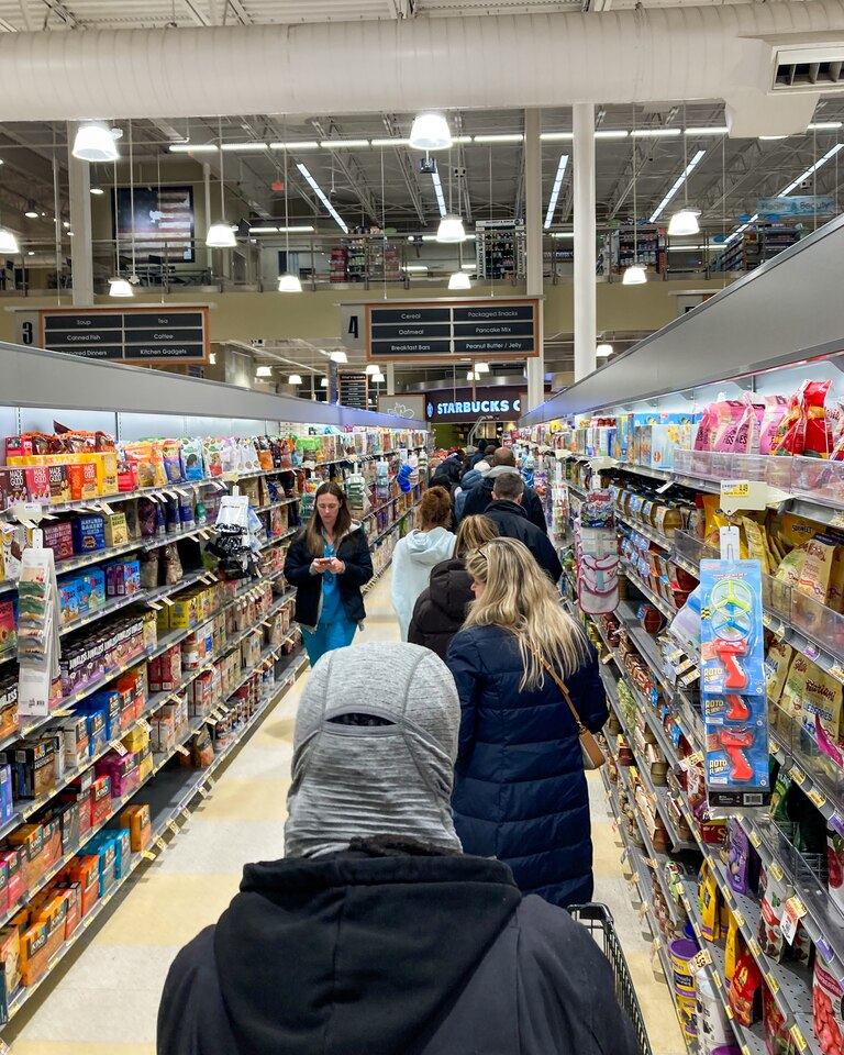 The line for self-checkout stretched through the Harris Teeter in Locust Point on Wednesday night ahead of a potential snowstorm.