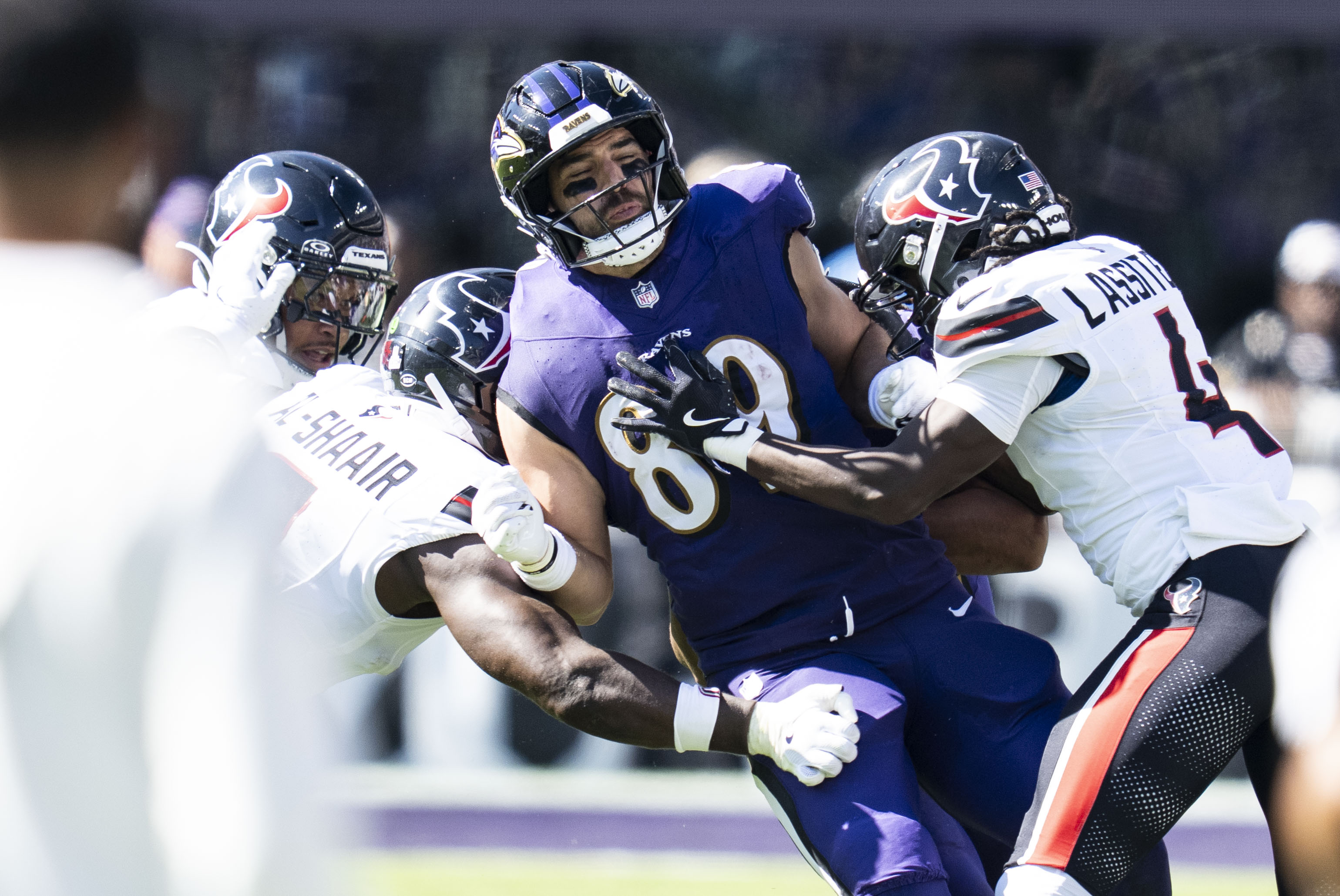 Texans defenders sandwich Ravens tight end Mark Andrews on Sunday during Houston’s 44-10 victory.