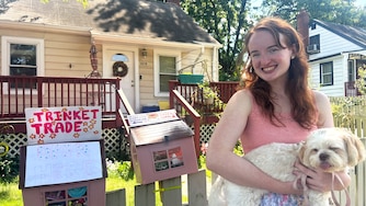 Jojo Craven poses with her dog, Halo, outside her trinket library outside her house on Veirs Mill Road in Rockville on Wednesday.