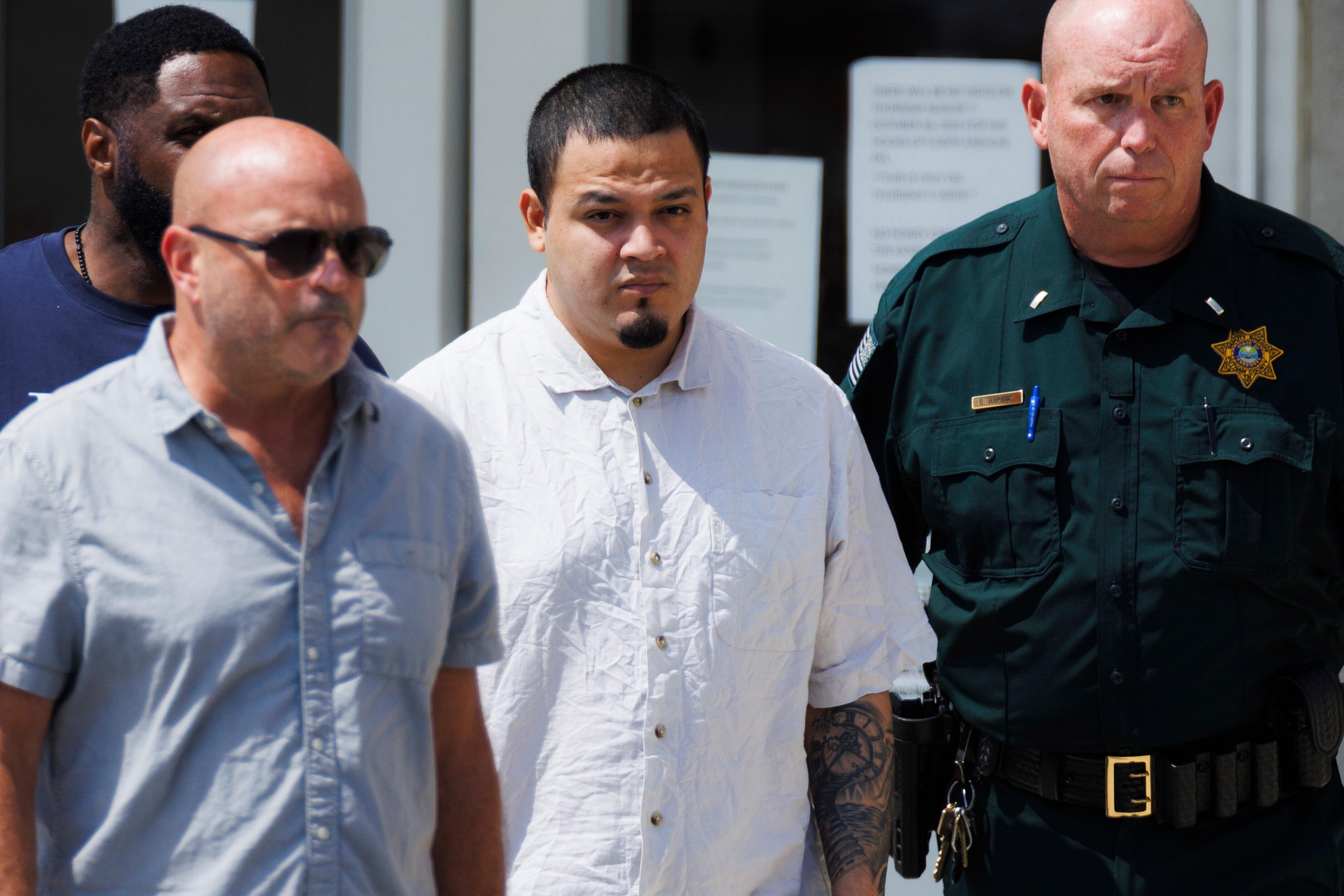 Kilmar Abrego Garcia, center, leaves the Putnam County Jail, Friday, Aug. 22, 2025, in Cookeville, Tenn. (AP Photo/Brett Carlsen)