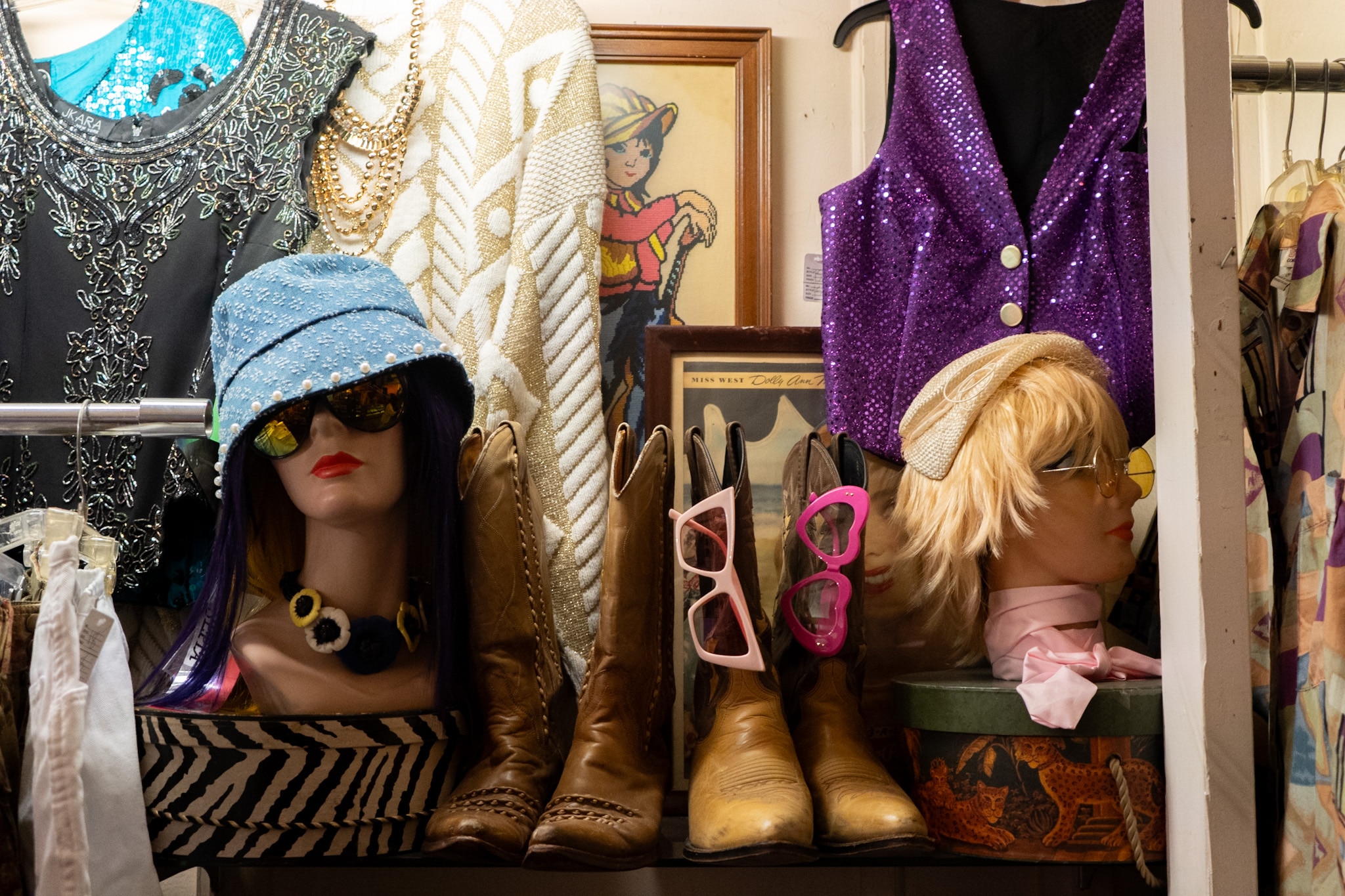 A variety of clothing items and accessories are seen on display at secondhand clothing store The Zone