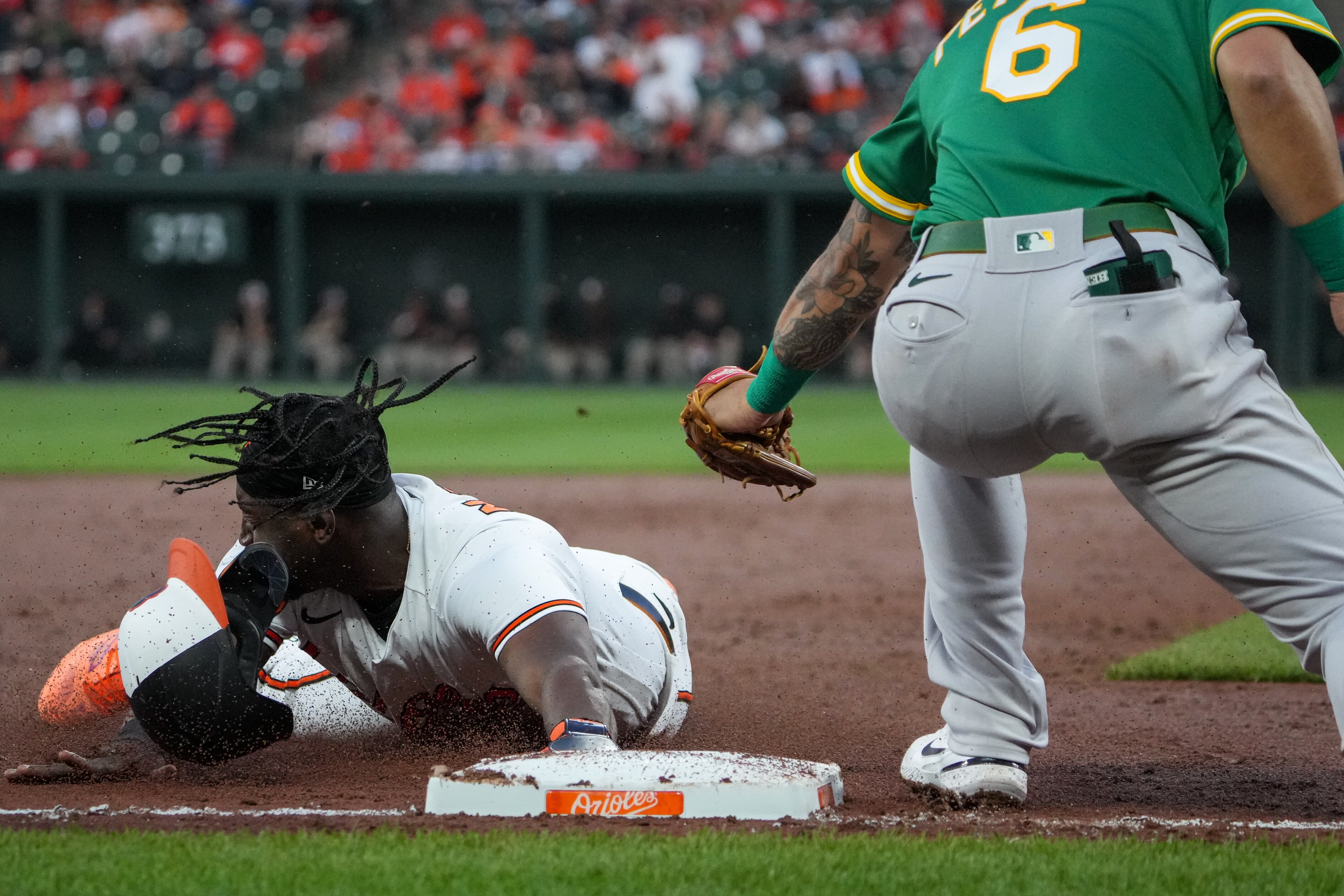 Orioles shortstop Jorge Mateo steals third base against the Athletics. A dramatic rise in steals has been one result of baseball's new rules implemented this season.