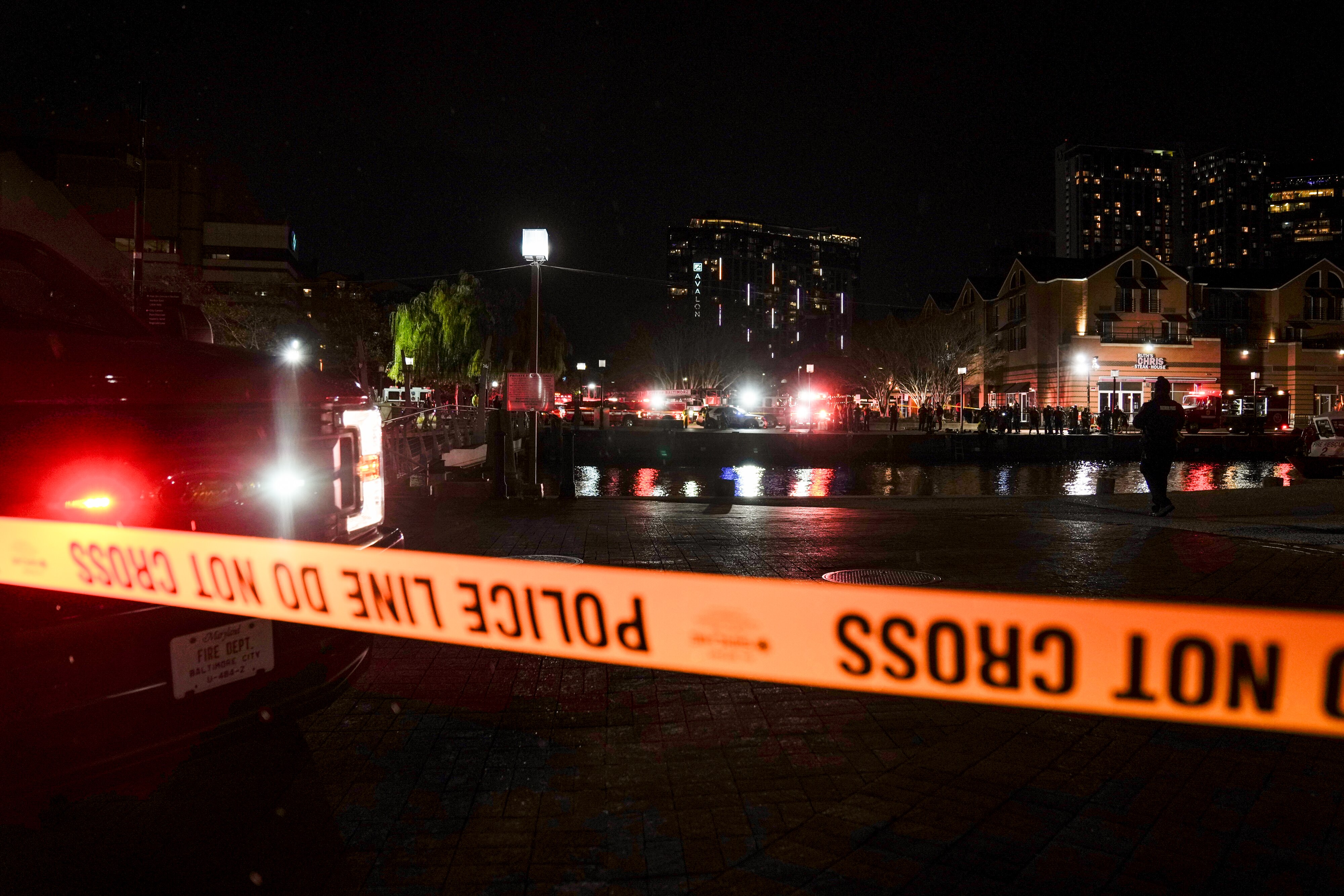 More than a dozen Baltimore fire trucks and police cars lined the area near the Pier 5 Pavilion on Tuesday, Nov. 18, 2025, as divers entered the water and rescue boats searched for the water.